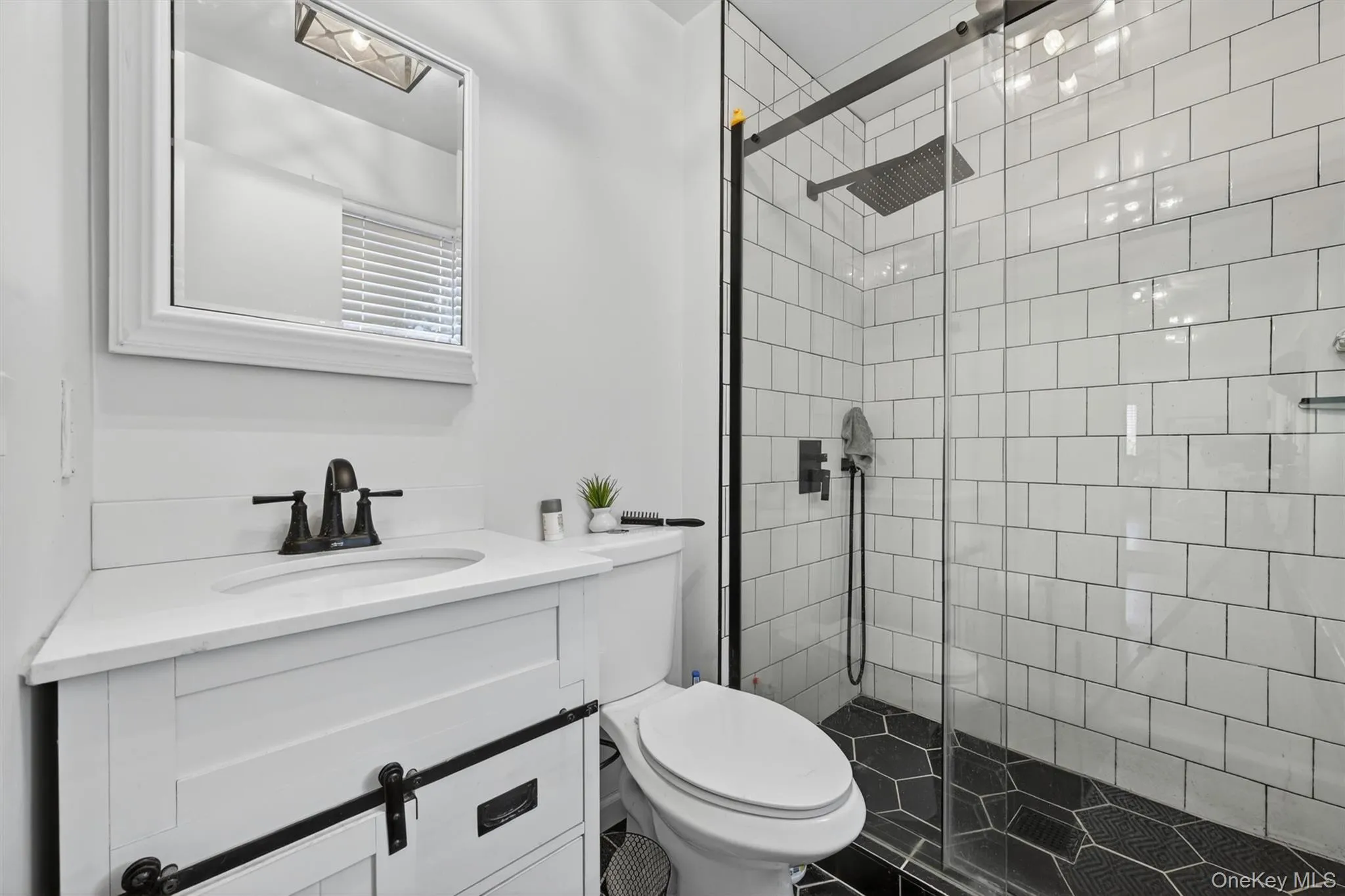 Updated bathroom with custom tile and glass doors. Updated bathroom with custom tile and glass doors.