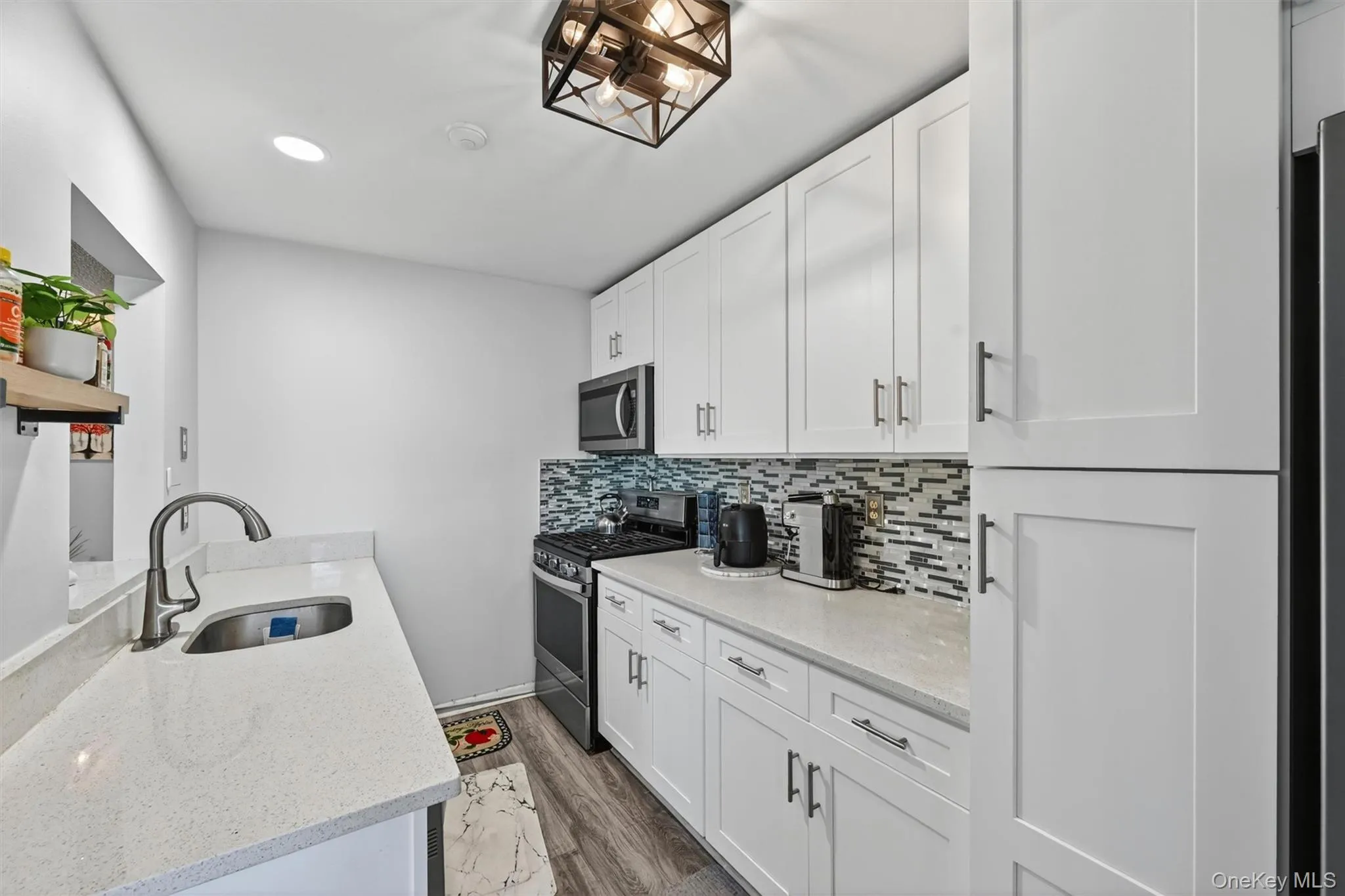Custom kitchen with tile backsplash, stainless steel appliances and white cabinets. Custom kitchen with tile backsplash, stainless steel appliances and white cabinets.