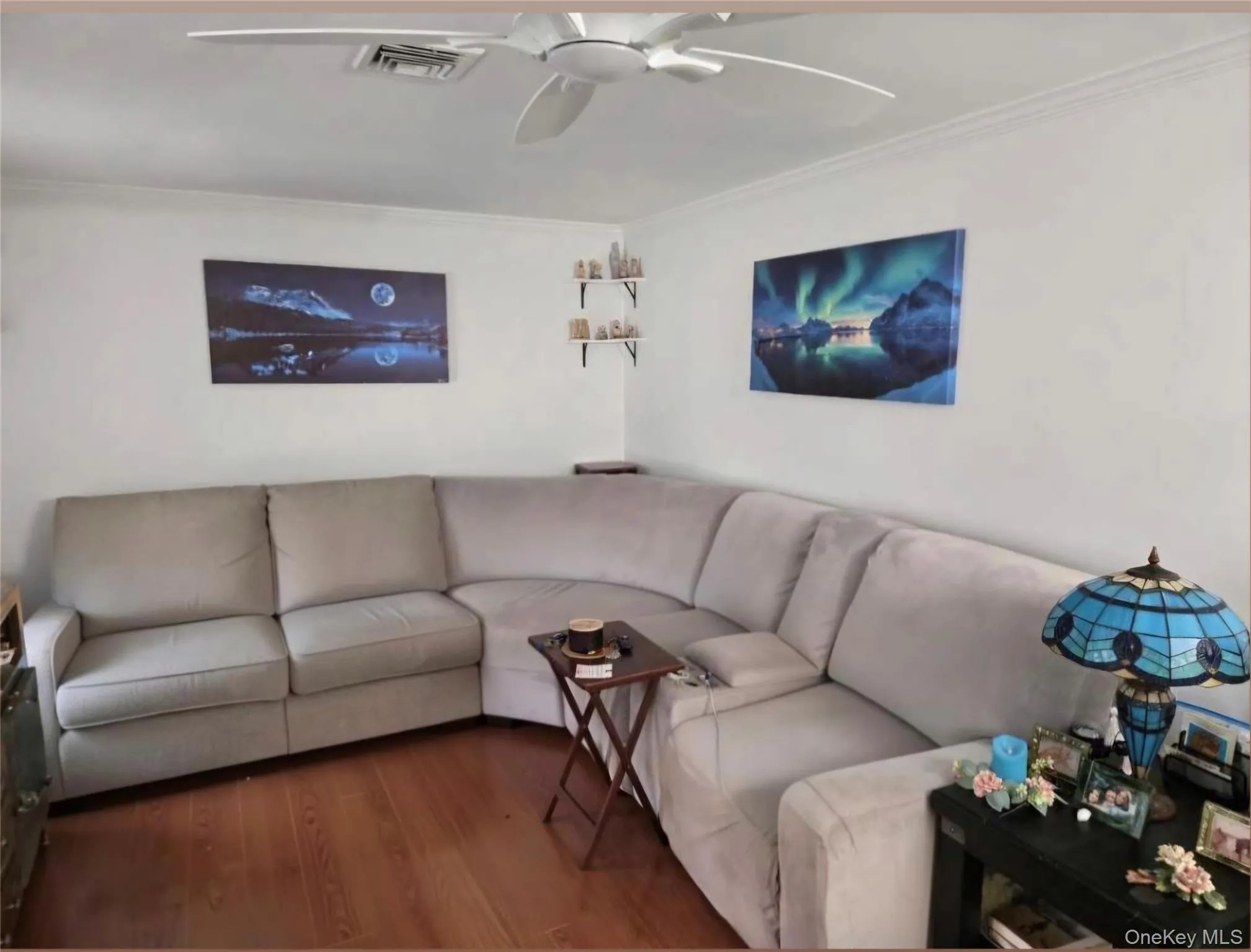 White-painted walls with crown molding and laminate flooring. Digitally removed personal items White-painted walls with crown molding and laminate flooring. Digitally removed personal items