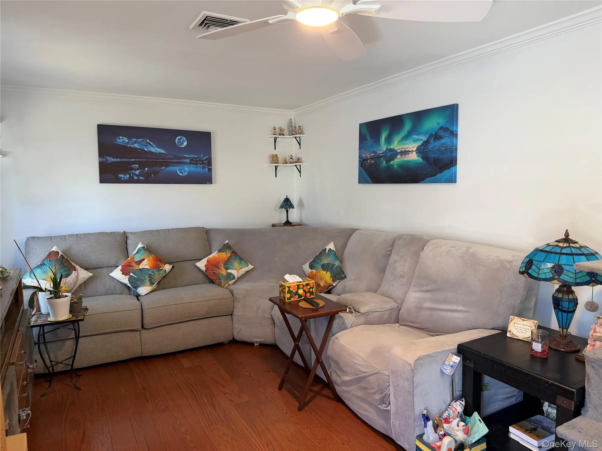White-painted walls with crown molding and laminate flooring. Digitally removed personal items White-painted walls with crown molding and laminate flooring. Digitally removed personal items
