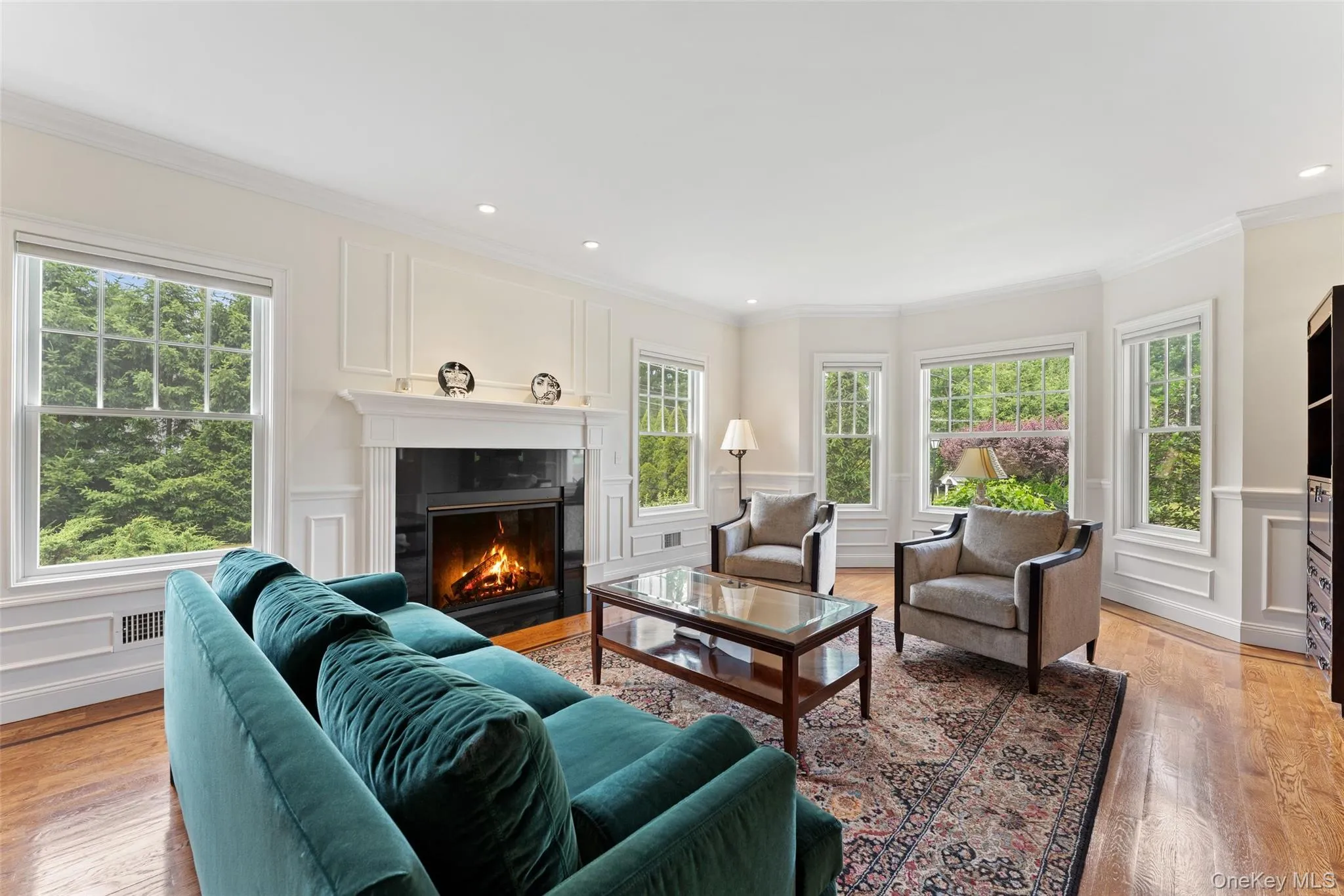 Living Room featuring a gas fireplace with a dark stone surround and white mantel Living Room featuring a gas fireplace with a dark stone surround and white mantel