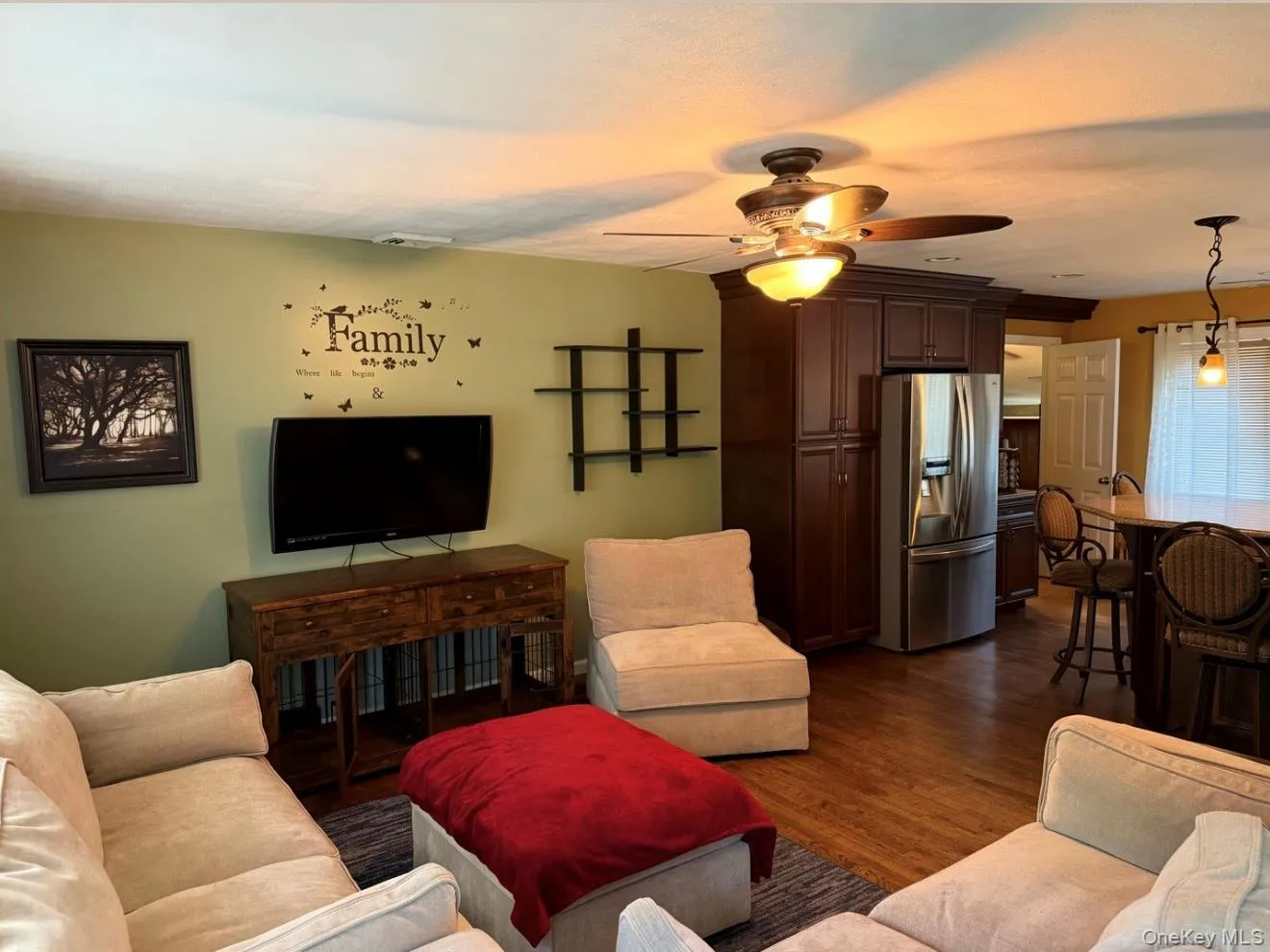 Open-concept living area featuring wood-finish flooring, a ceiling fan with integrated lighting, and recessed lighting. Digitally removed personal items Open-concept living area featuring wood-finish flooring, a ceiling fan with integrated lighting, and recessed lighting. Digitally removed personal items
