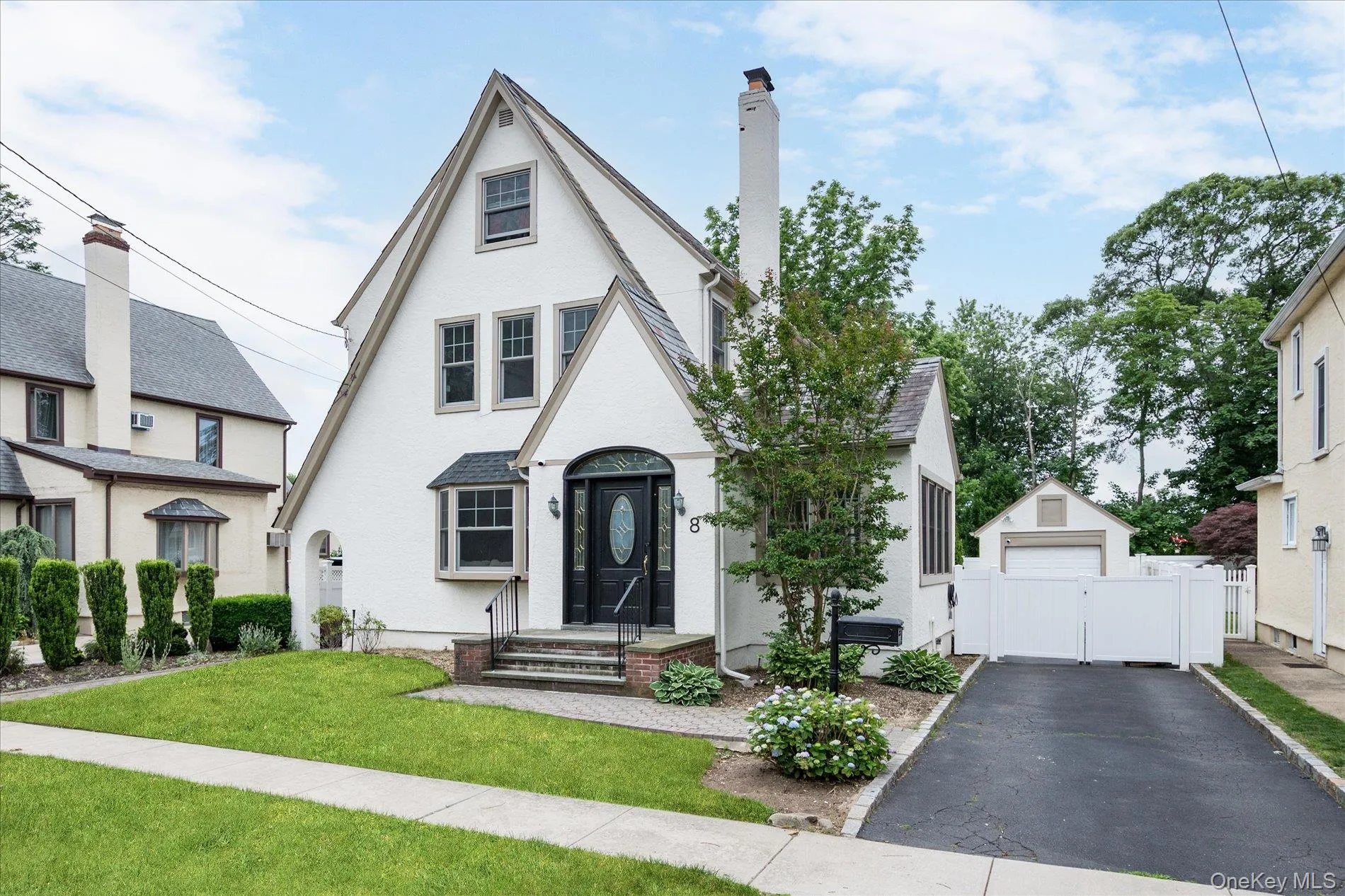 White stucco exterior with a prominent gabled roofline White stucco exterior with a prominent gabled roofline
