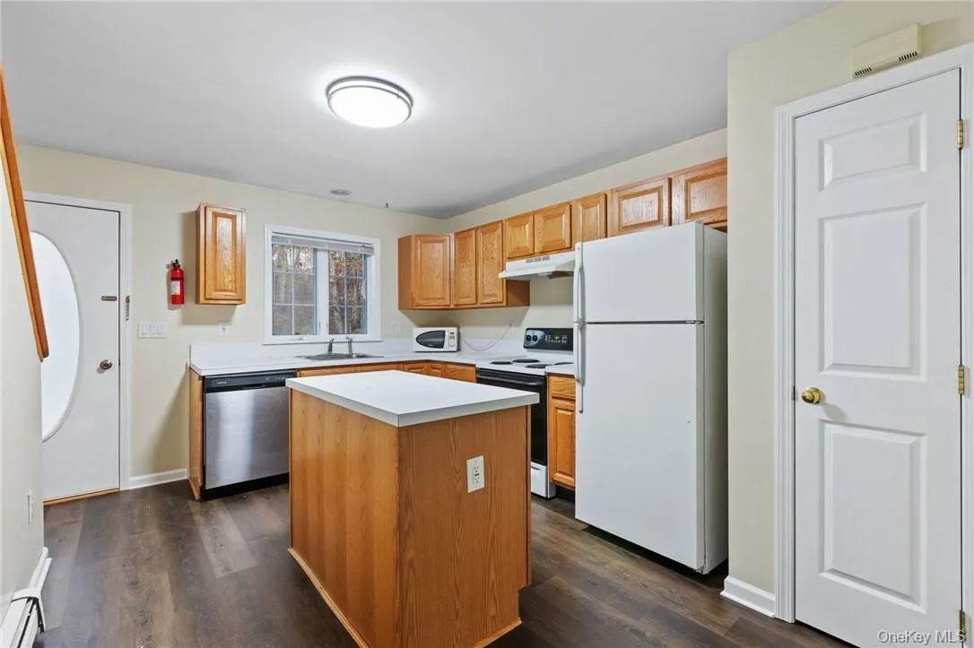 Laminate flooring and center island highlight the kitchen Laminate flooring and center island highlight the kitchen