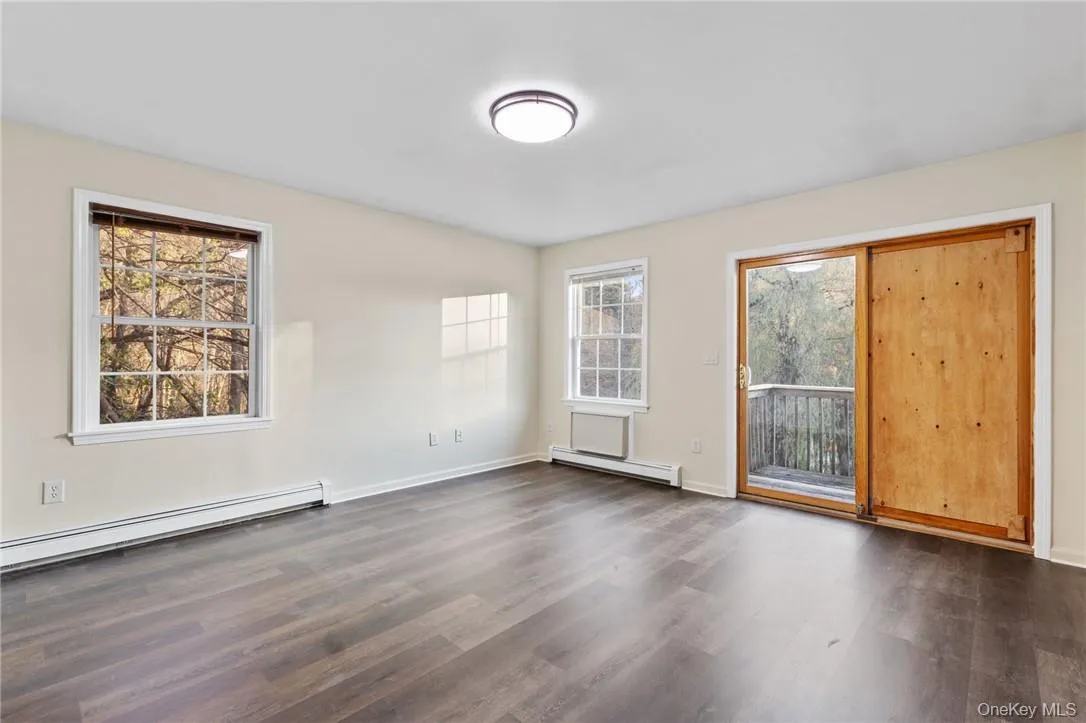 Upstairs bedroom has sliders to the deck with lake views Upstairs bedroom has sliders to the deck with lake views
