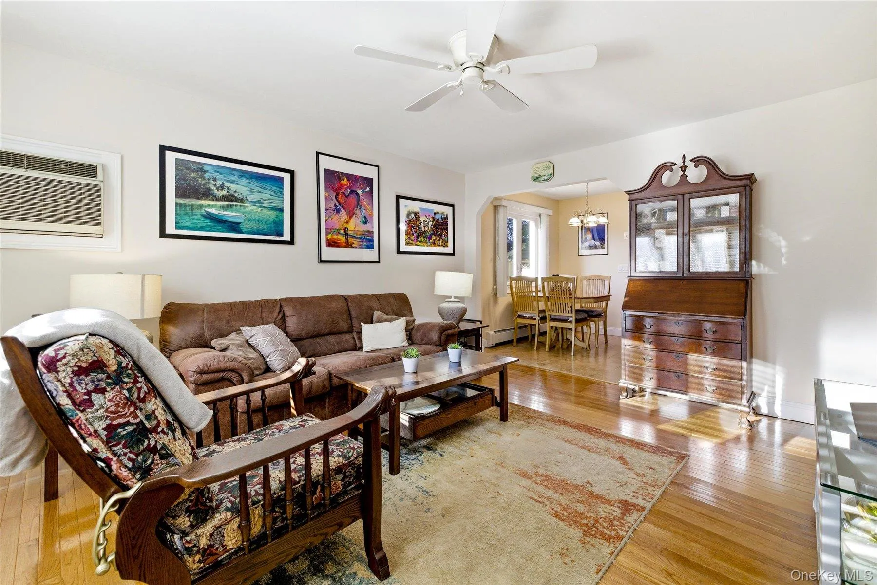 Living area featuring wood floors with a dining nook Living area featuring wood floors with a dining nook