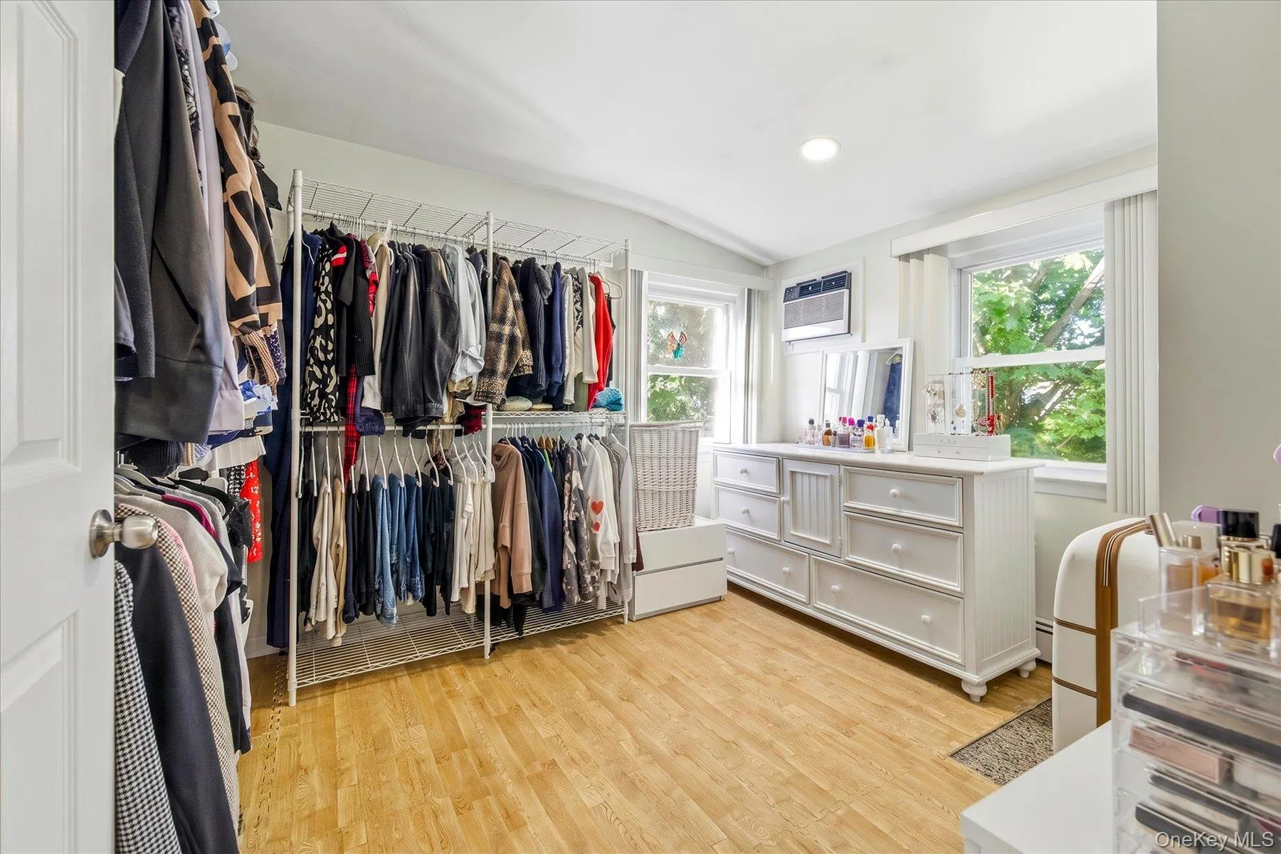 Spacious bedroom featuring wood floors and two large windows Spacious bedroom featuring wood floors and two large windows