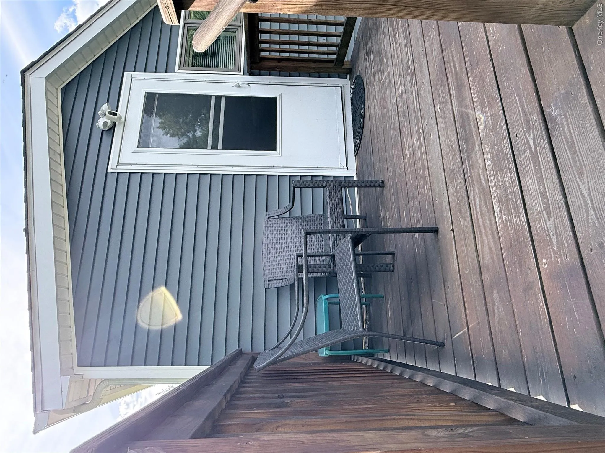 Exterior deck featuring horizontal wood planks and wood railings Exterior deck featuring horizontal wood planks and wood railings