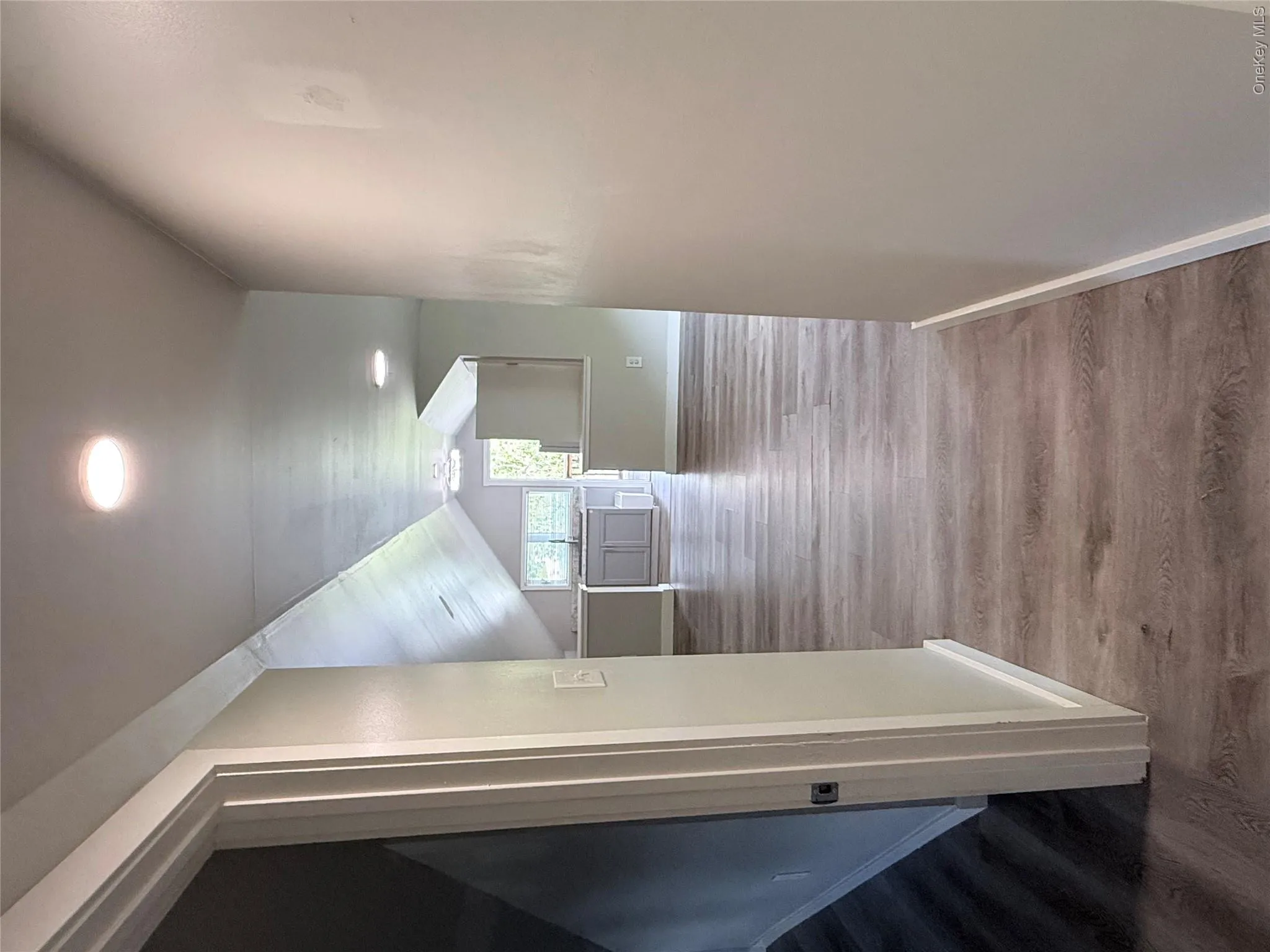 Expansive wood-finish flooring extends throughout, complemented by recessed lighting and light-toned wall finishes Expansive wood-finish flooring extends throughout, complemented by recessed lighting and light-toned wall finishes