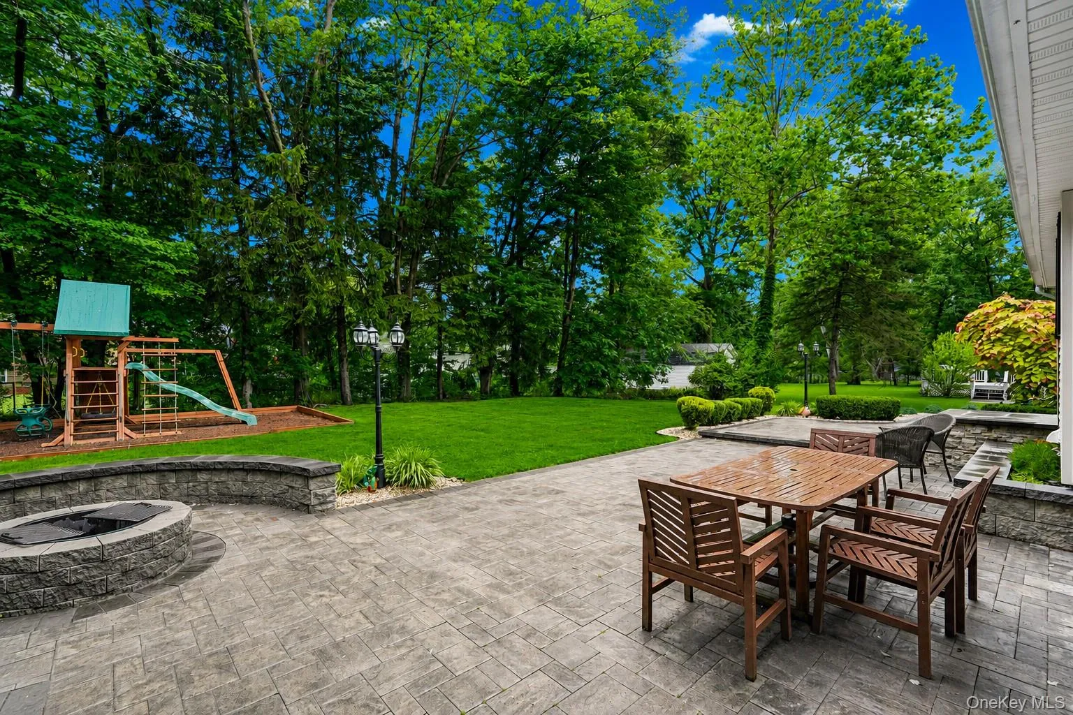 Wood burning fire pit, lots of patio space for entertaining, plenty of green grass on a level .38 acres Wood burning fire pit, lots of patio space for entertaining, plenty of green grass on a level .38 acres