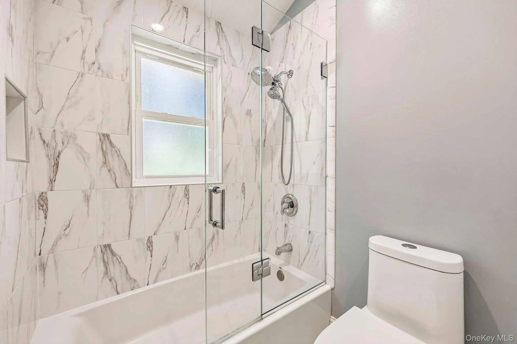 Hallway bath has a tub/shower combo recently renovated in 2023 Hallway bath has a tub/shower combo recently renovated in 2023