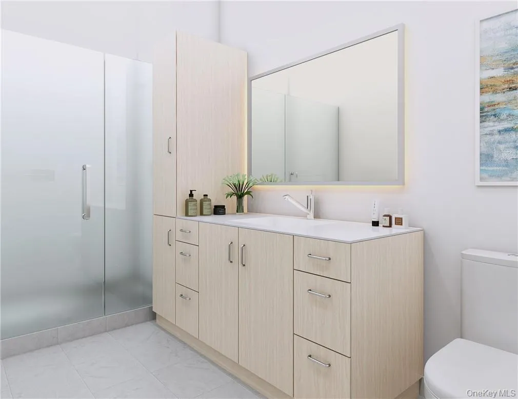 Bathroom featuring vanity, toilet, an enclosed shower, and tile patterned floors Bathroom featuring vanity, toilet, an enclosed shower, and tile patterned floors