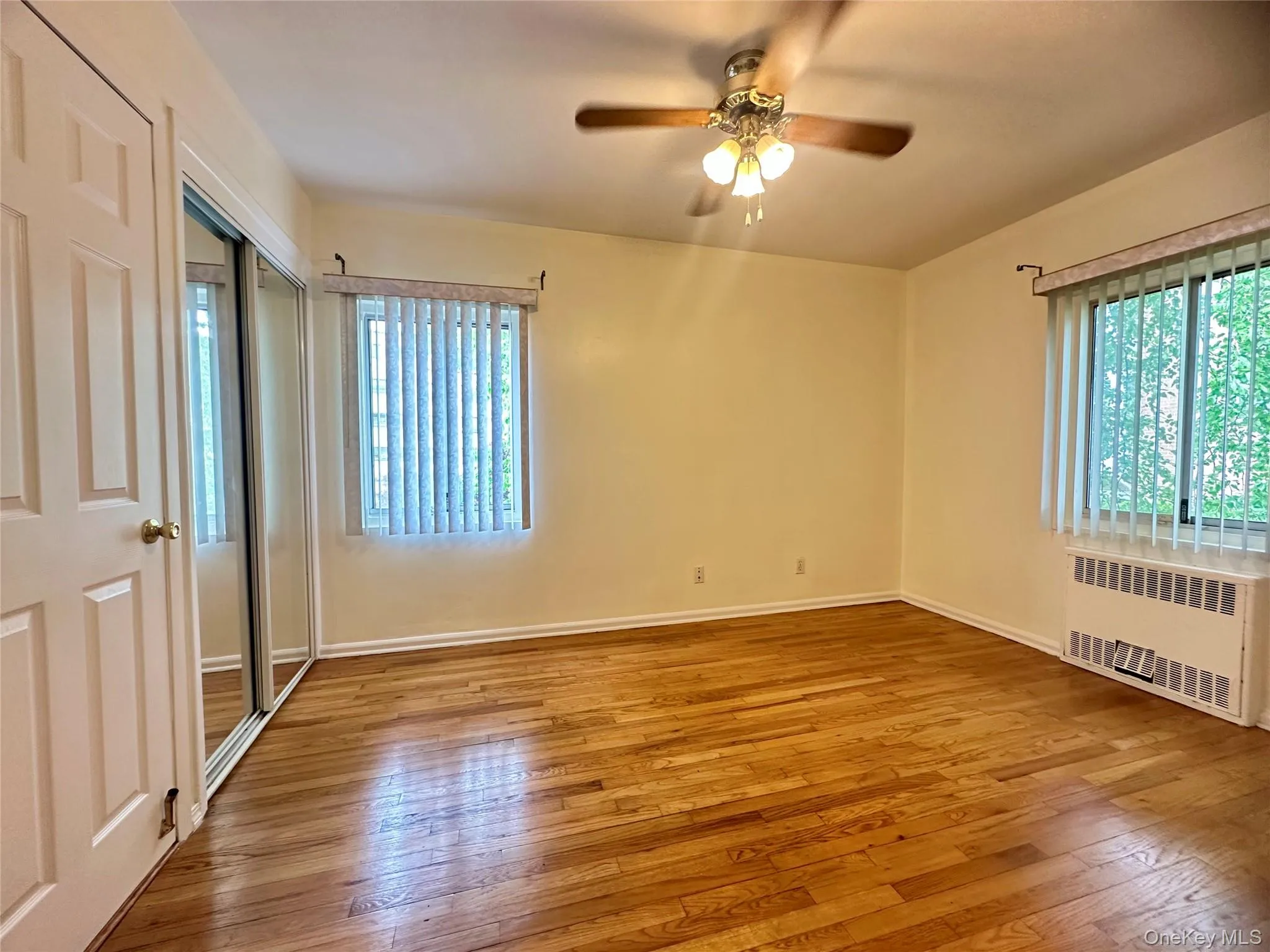 Bedroom 1 with dual closets, ceiling fan, in-wall AC unit Bedroom 1 with dual closets, ceiling fan, in-wall AC unit