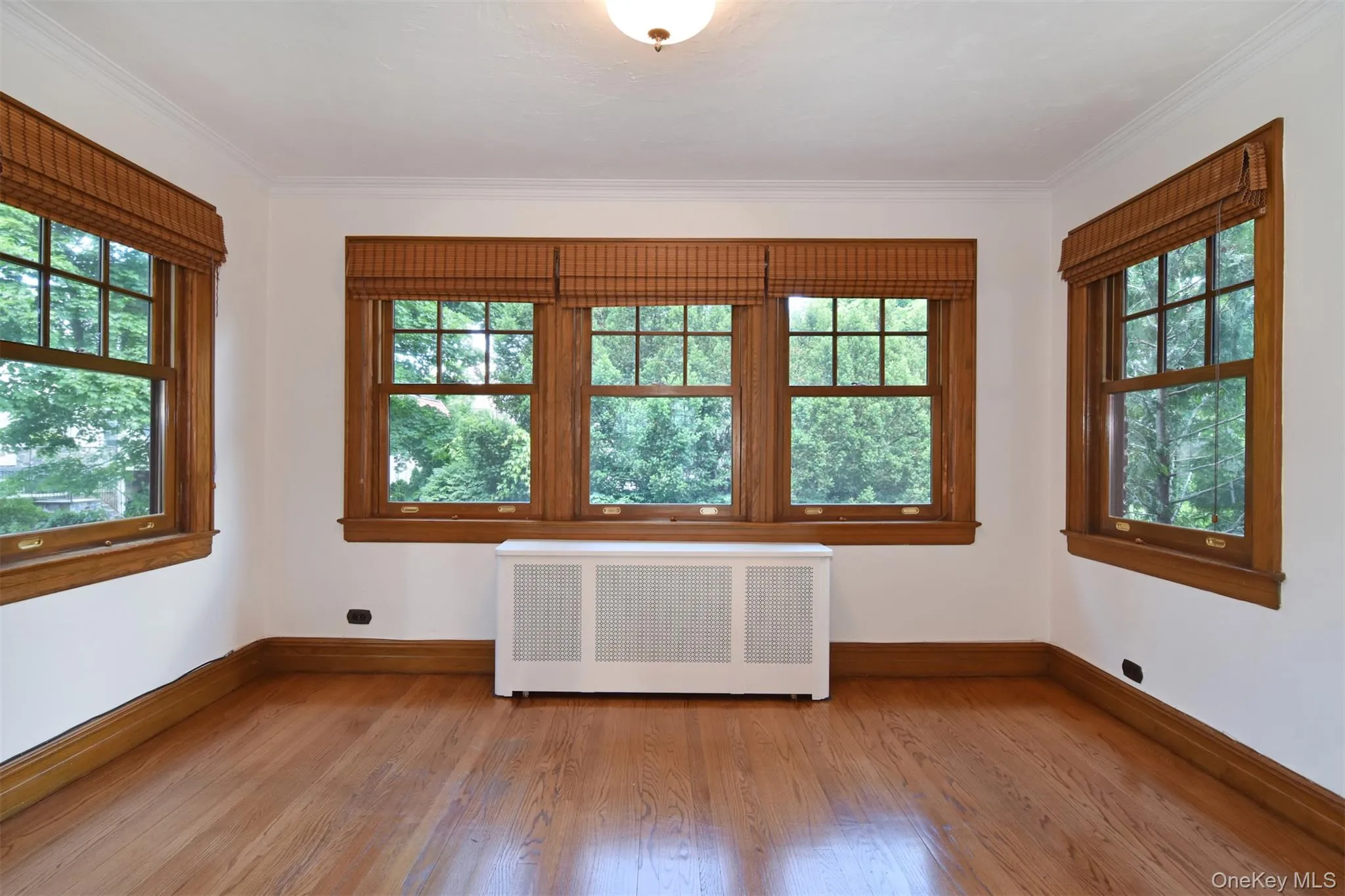Radiant sunroom/den/playroom with three walls of windows and shining woodwork Radiant sunroom/den/playroom with three walls of windows and shining woodwork