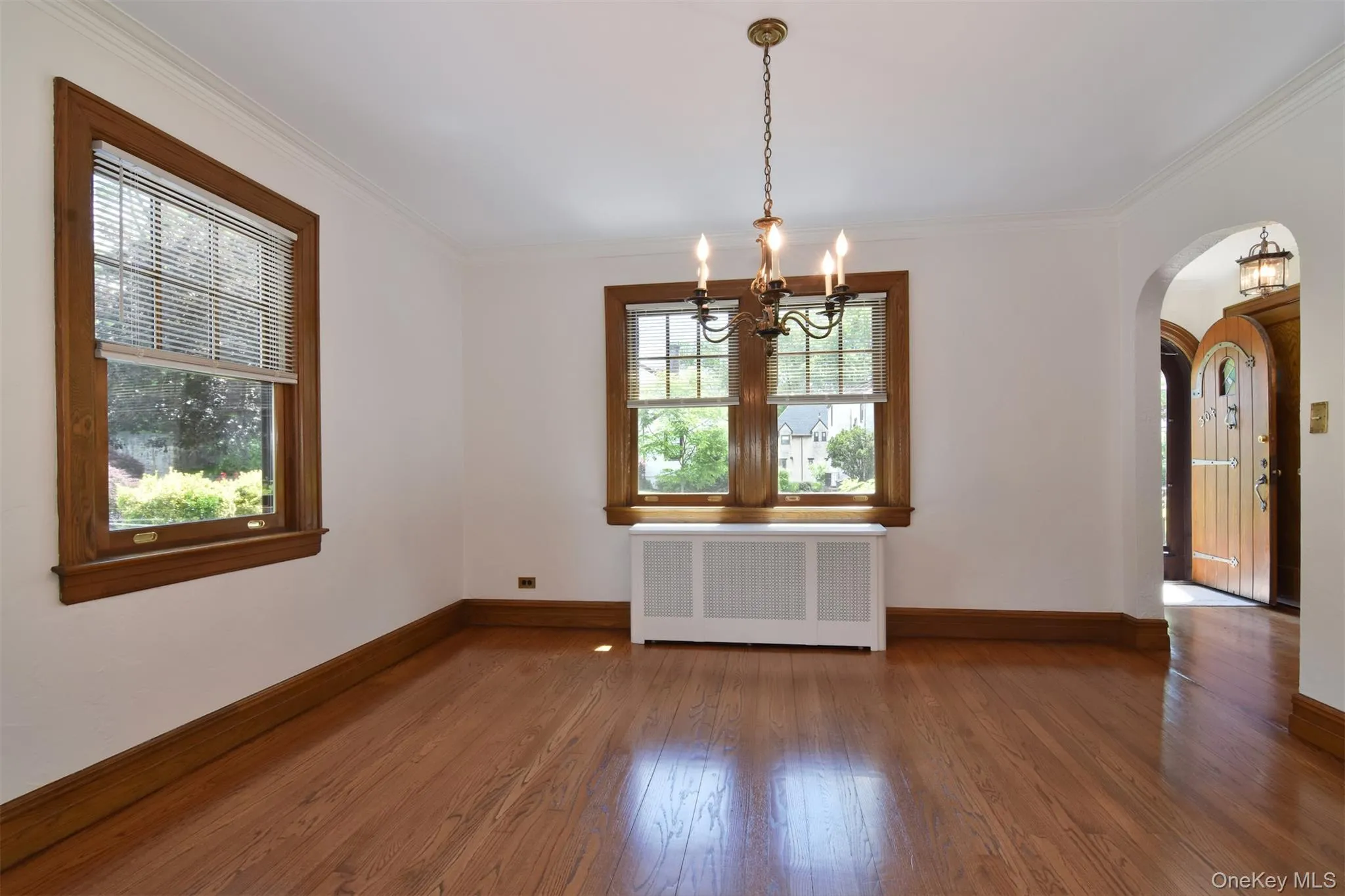 Formal dining room with chandelier and view to entry Formal dining room with chandelier and view to entry