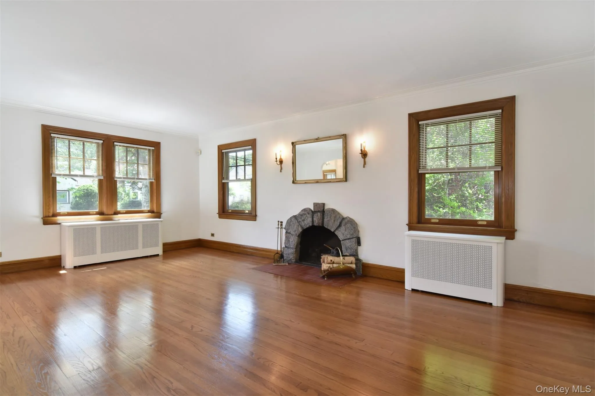 View from the sunroom showing hardwood floors and large windows View from the sunroom showing hardwood floors and large windows