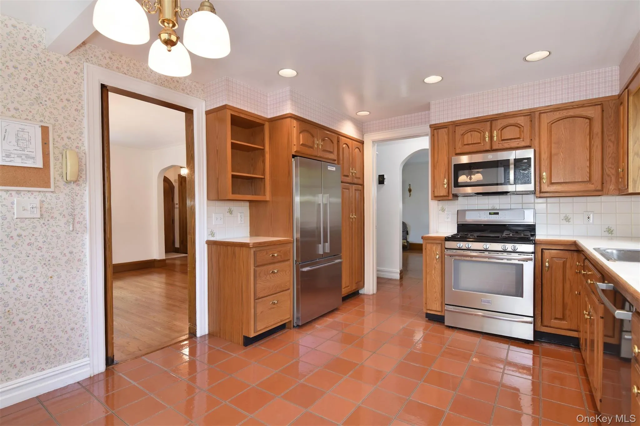 Modern kitchen with recessed lighting, stainless steel appliances and wood cabinetry Modern kitchen with recessed lighting, stainless steel appliances and wood cabinetry