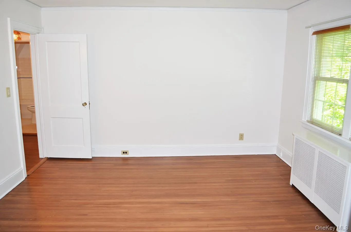 Primary bedroom with hardwood floors Primary bedroom with hardwood floors