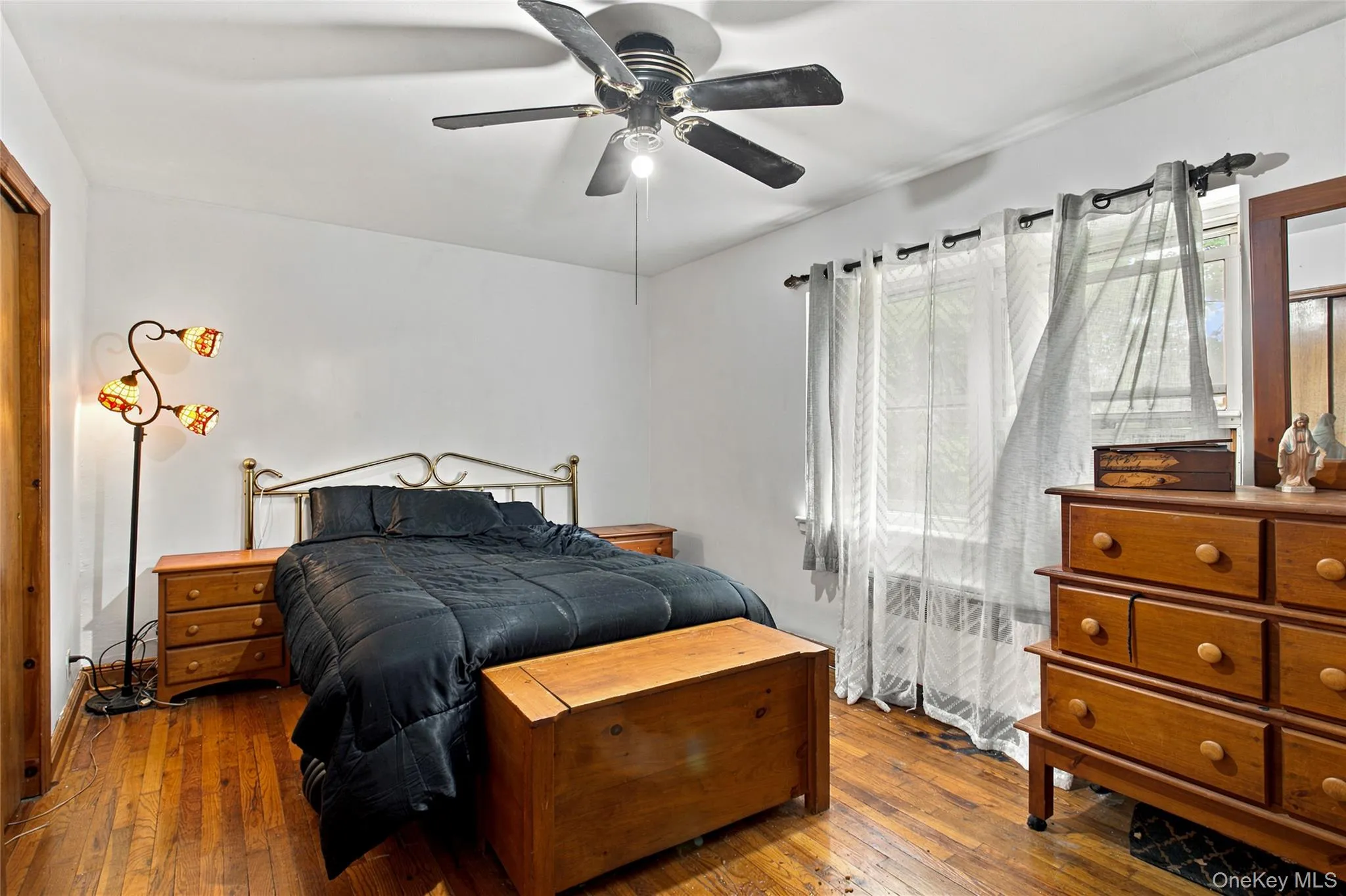 Your primary bedroom is spacious with large windows that bring in plenty of natural sunlight. It features hardwood floors and an overzed large closet. Your primary bedroom is spacious with large windows that bring in plenty of natural sunlight. It features hardwood floors and an overzed large closet.