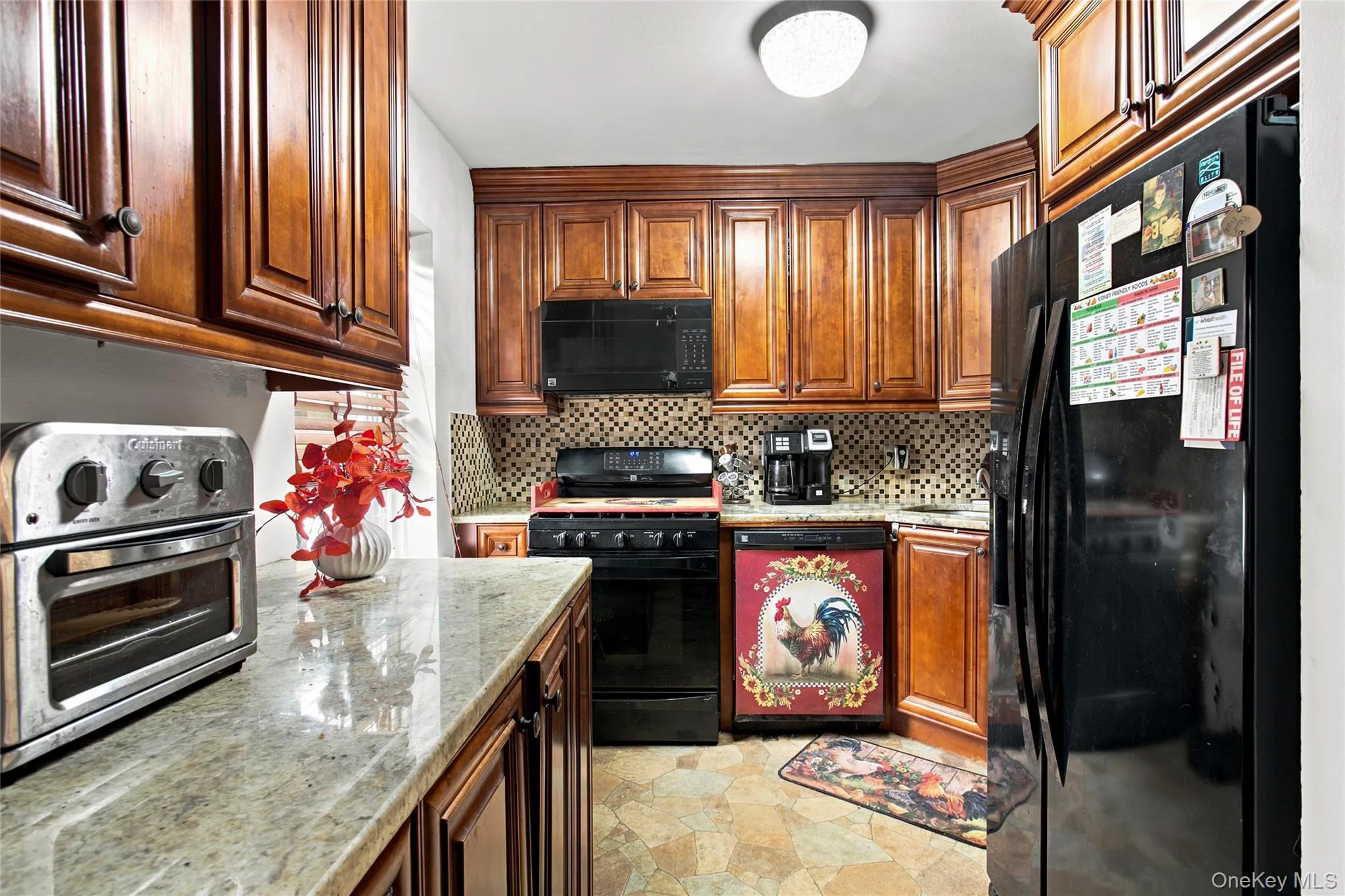 The kitchen with granite counters and built -in convenience.Your private laundry tucked neatly beneath te counter for a practical space saving setup The kitchen with granite counters and built -in convenience.Your private laundry tucked neatly beneath te counter for a practical space saving setup
