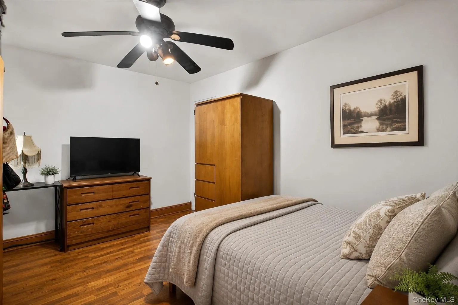 The second bedroom offers cozy comfort with single closet storage and hardwood floors The second bedroom offers cozy comfort with single closet storage and hardwood floors