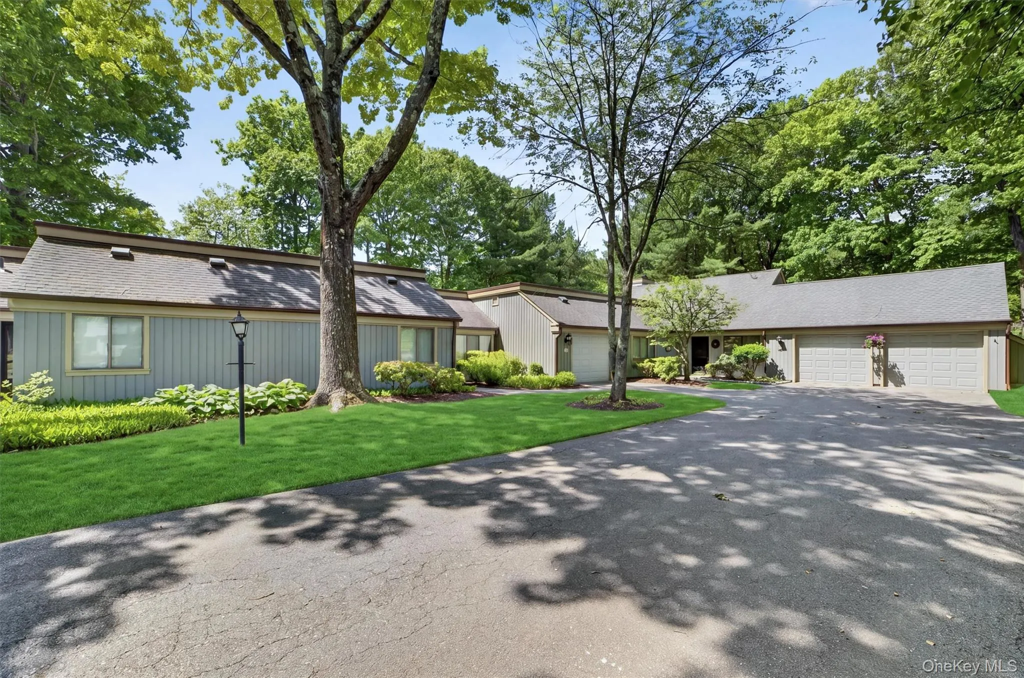 Ranch-style residence featuring a grey shingle roof and light grey siding Ranch-style residence featuring a grey shingle roof and light grey siding