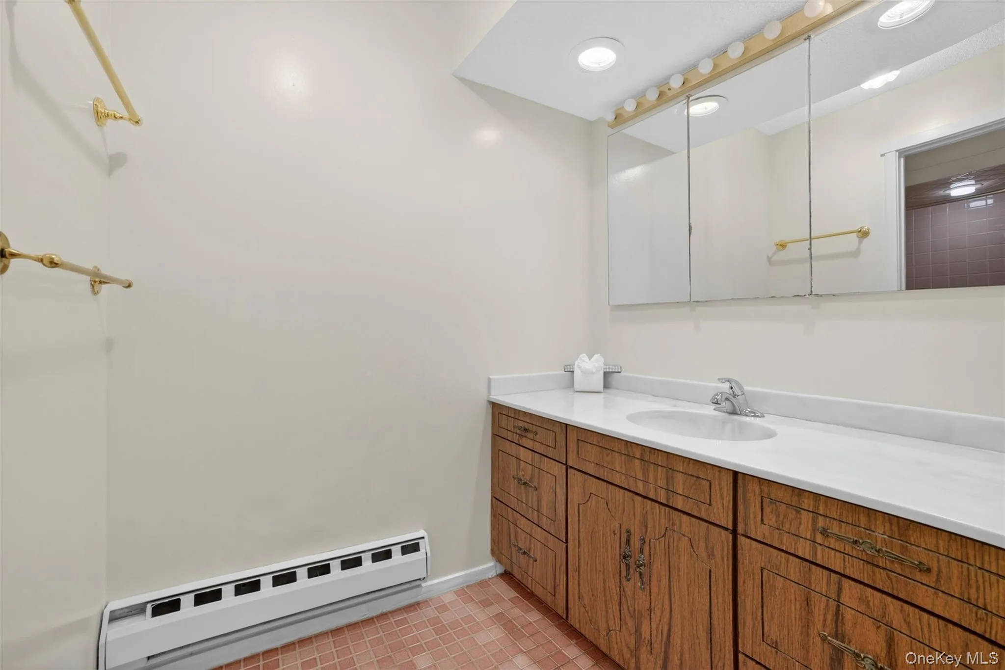 Bathroom vanity featuring an integrated sink, polished chrome faucet, and expansive countertop Bathroom vanity featuring an integrated sink, polished chrome faucet, and expansive countertop