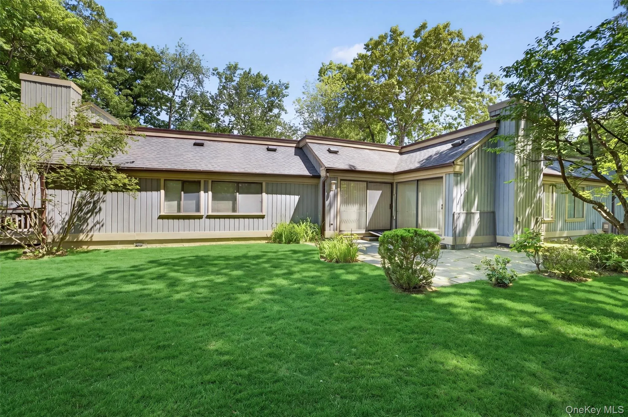 Expansive lawn area bordering the property, featuring mature trees and established landscaping Expansive lawn area bordering the property, featuring mature trees and established landscaping