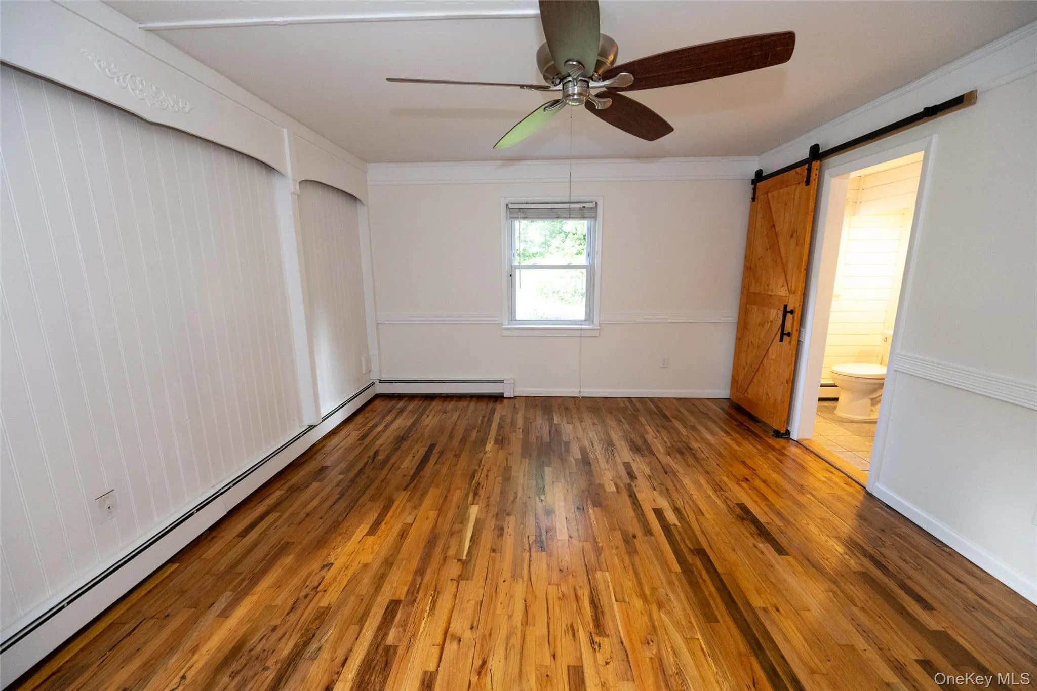 Primary Bedroom with Barn door entry to primary bathroom Primary Bedroom with Barn door entry to primary bathroom