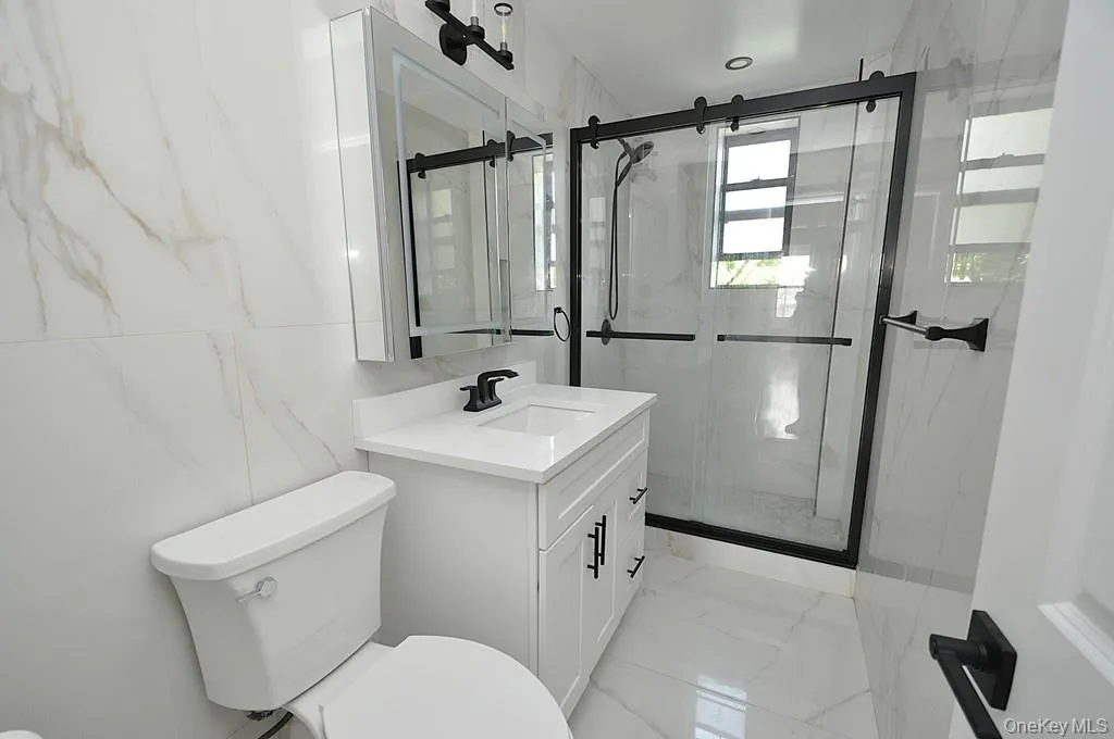 Fully Renovated bathroom with step in shower. Fully Renovated bathroom with step in shower.