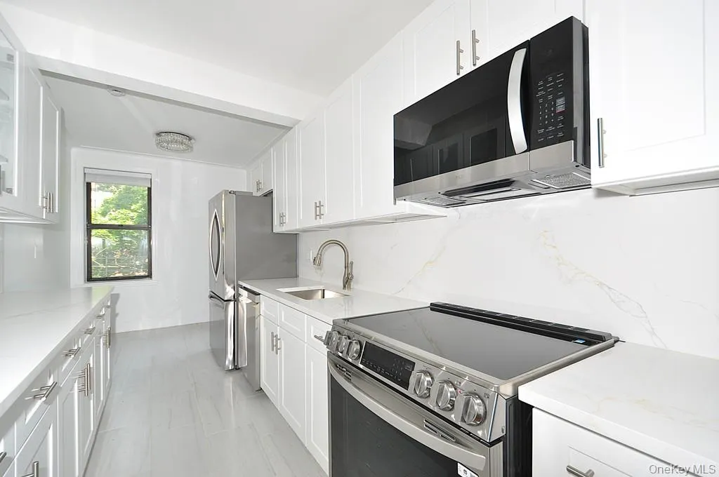 Renovated eat-in-kitchen with stainless steel appliances and quartz counters. Renovated eat-in-kitchen with stainless steel appliances and quartz counters.
