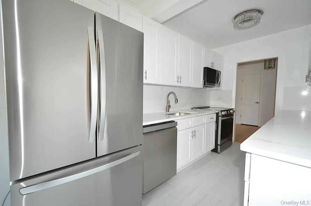 Renovated eat-in-kitchen with stainless steel appliances and quartz counters. Renovated eat-in-kitchen with stainless steel appliances and quartz counters.