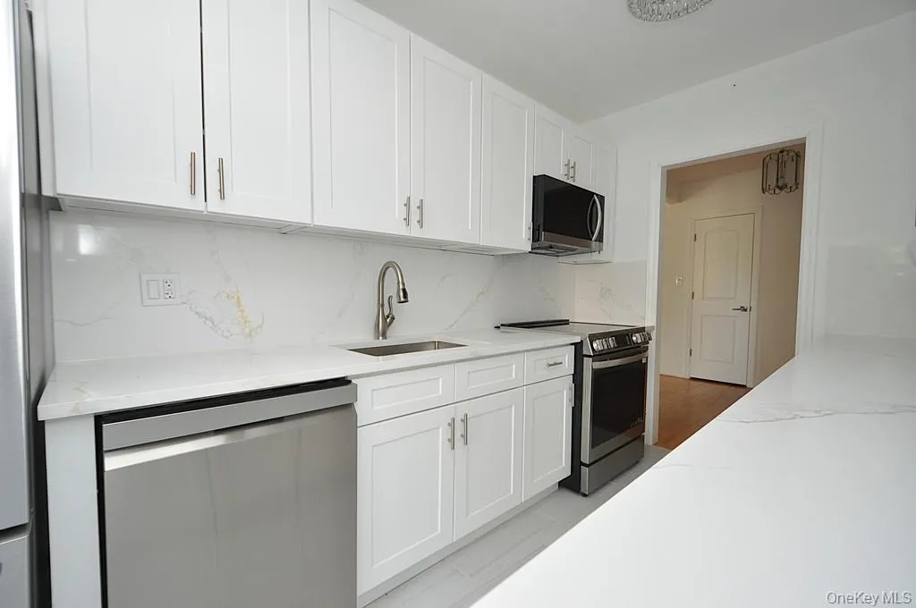 Renovated eat-in-kitchen with stainless steel appliances and quartz counters. Renovated eat-in-kitchen with stainless steel appliances and quartz counters.