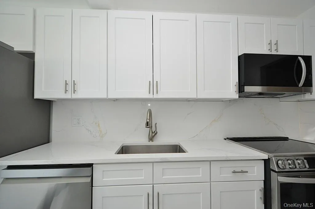 Renovated eat-in-kitchen with stainless steel appliances and quartz counters. Renovated eat-in-kitchen with stainless steel appliances and quartz counters.