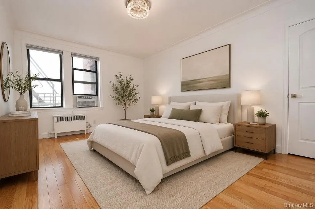 Photo is visually staged. Bedroom with walk-in closet and refinished hardwood floors. The bedroom is approx. 16'-2" x 11'-11". Photo is visually staged. Bedroom with walk-in closet and refinished hardwood floors. The bedroom is approx. 16'-2" x 11'-11".