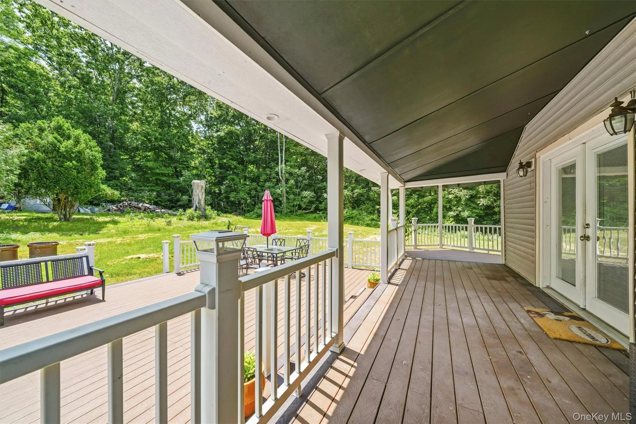 Expansive, wraparound covered deck to larger, open entertainment space Expansive, wraparound covered deck to larger, open entertainment space