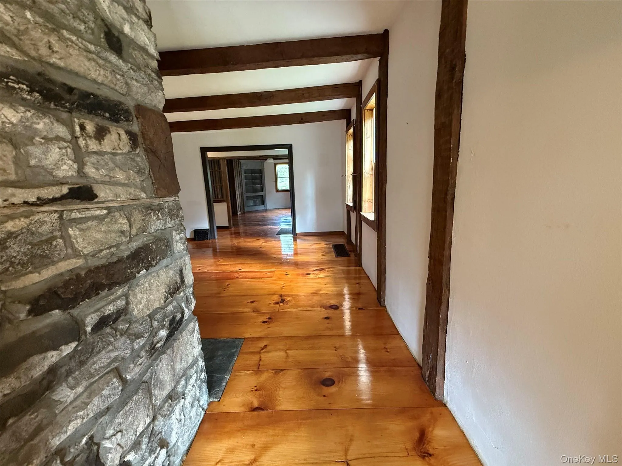 Hall with hardwood / wood-style floors and beamed ceiling Hall with hardwood / wood-style floors and beamed ceiling
