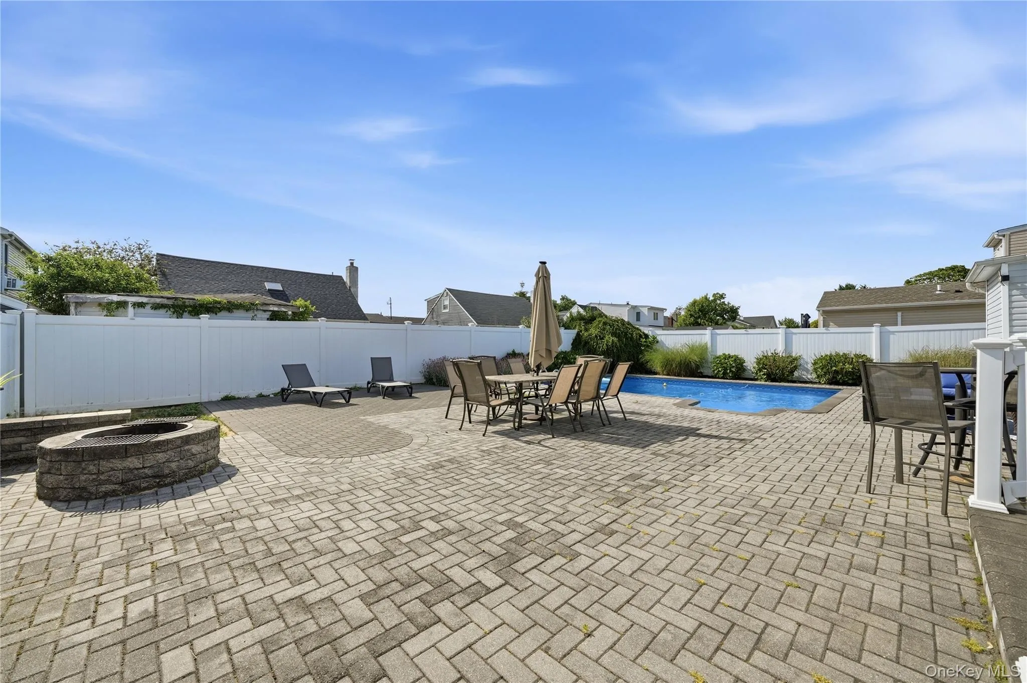 Fenced in paved backyard with in ground pool and firepit. Fenced in paved backyard with in ground pool and firepit.