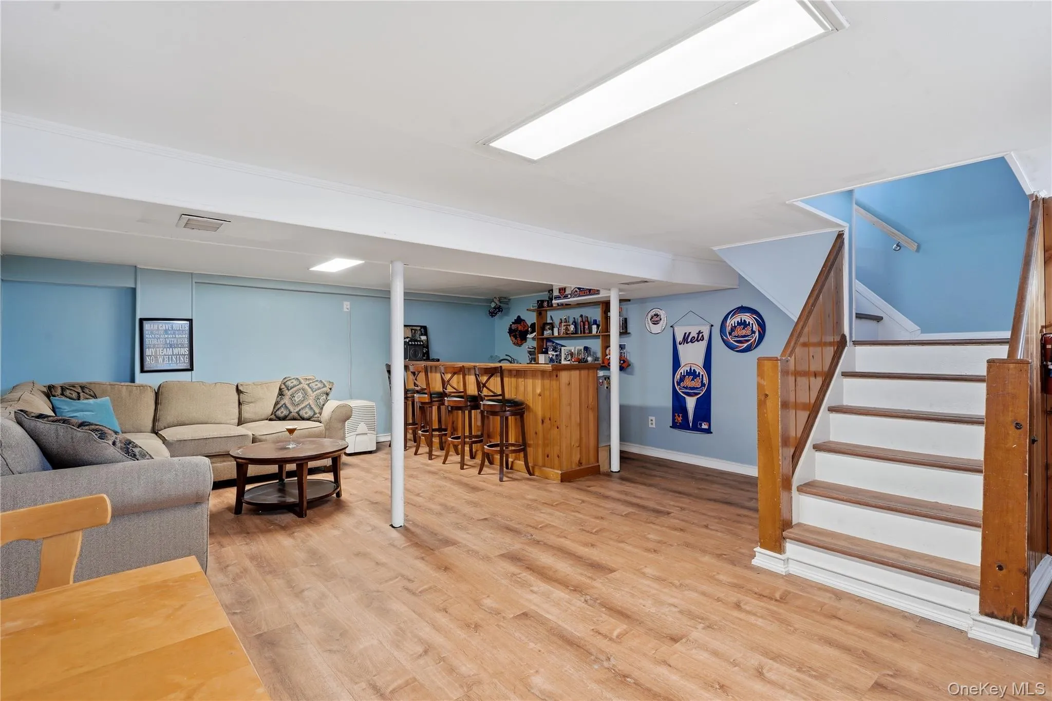 Lower level family room with wet bar and new flooring. Lower level family room with wet bar and new flooring.