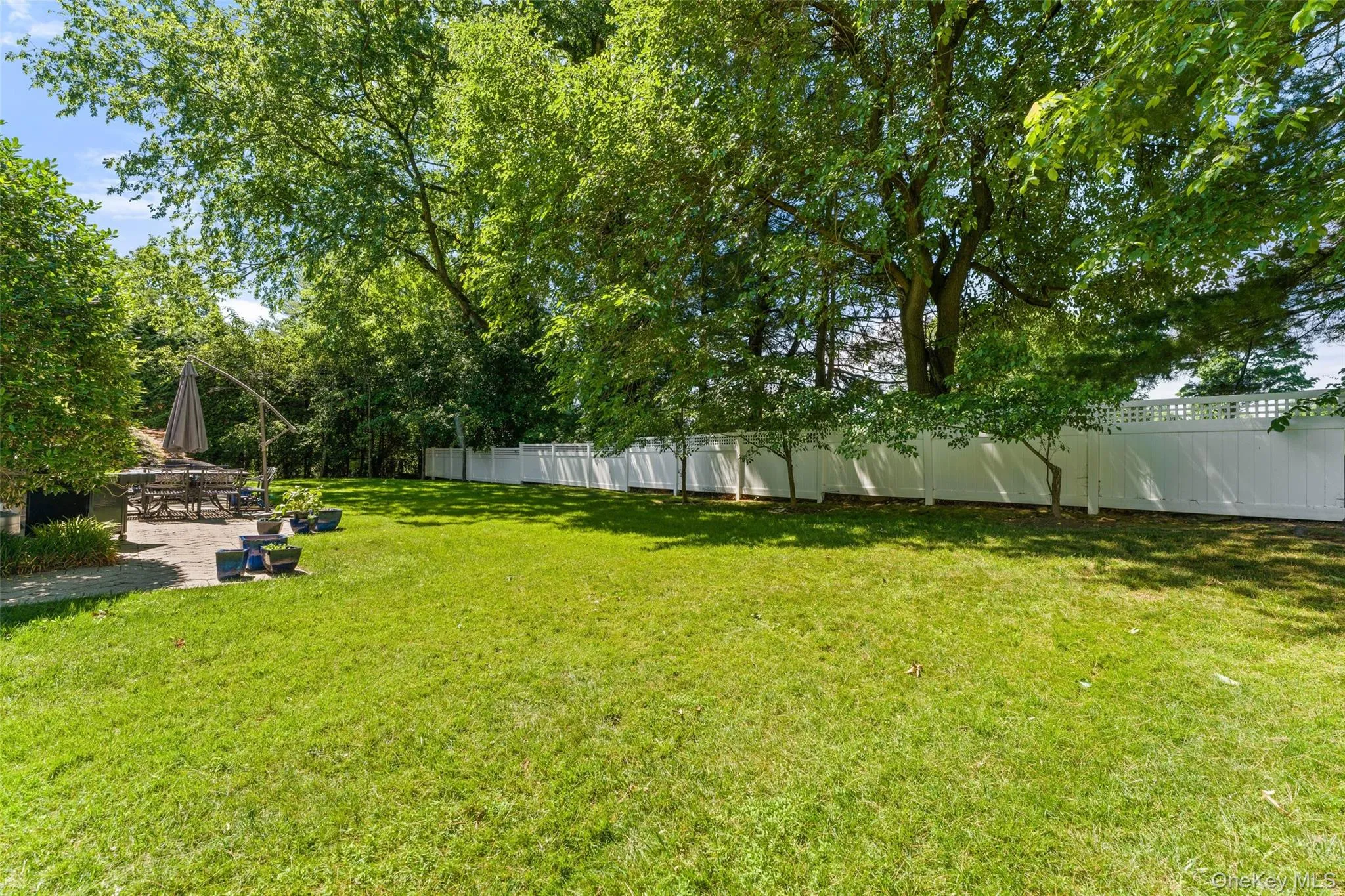 Flat, fenced yard with mature landscaping for privacy Flat, fenced yard with mature landscaping for privacy