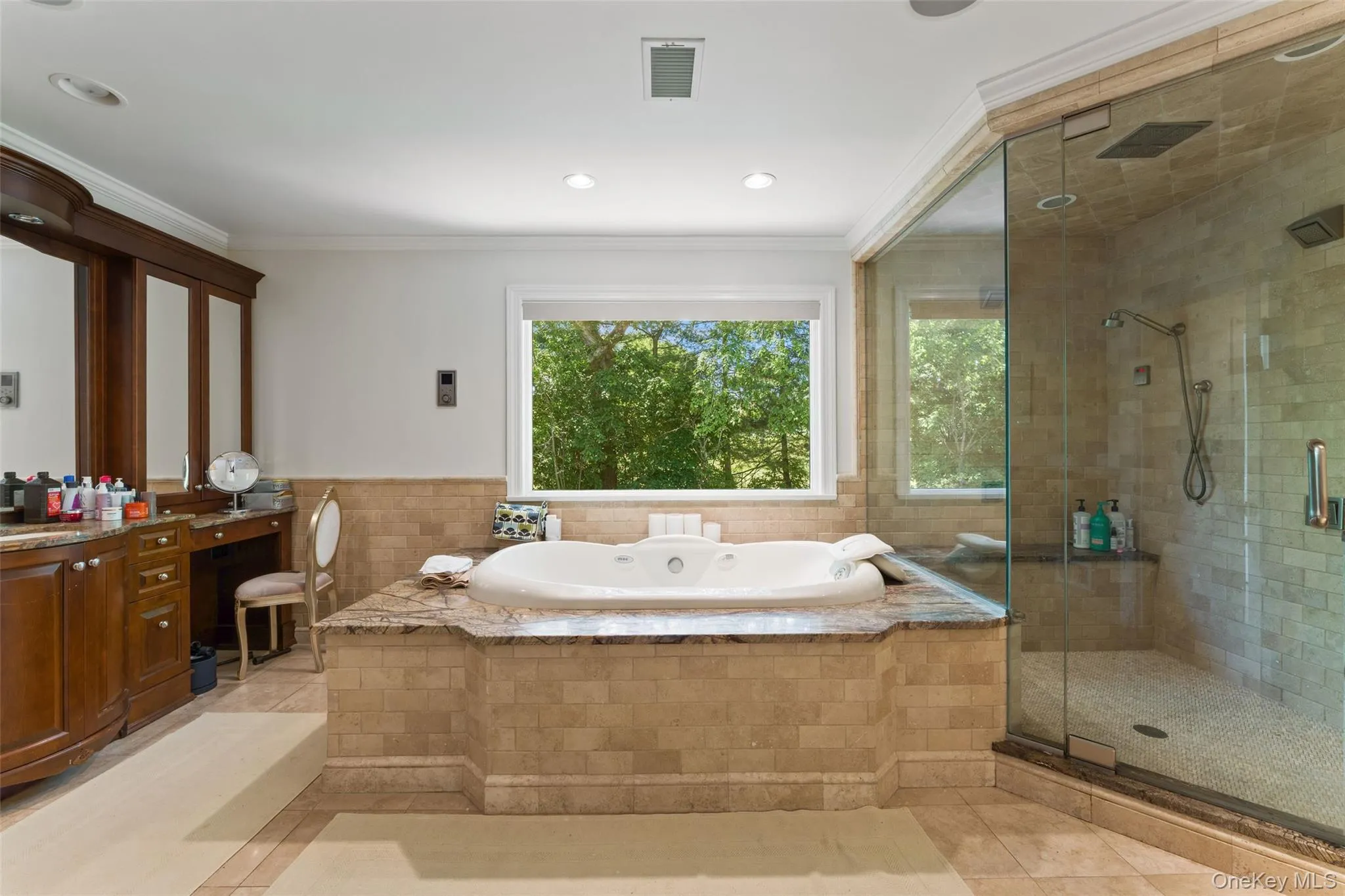 Spa like ensuite primary bathroom with double vanity, large tub and glass enclosed shower Spa like ensuite primary bathroom with double vanity, large tub and glass enclosed shower