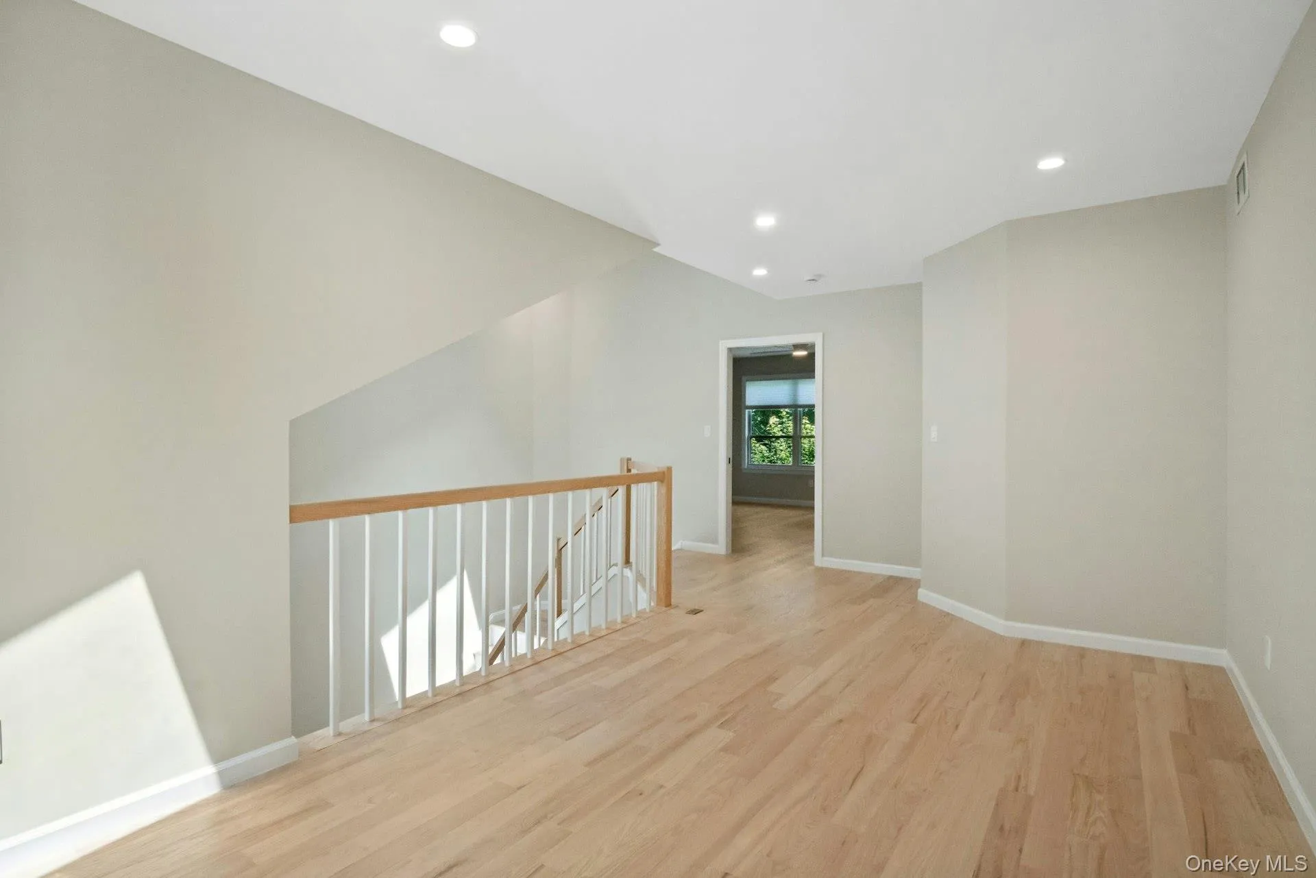 Open floor plan loft features hardwood floors and recessed lights. Open floor plan loft features hardwood floors and recessed lights.