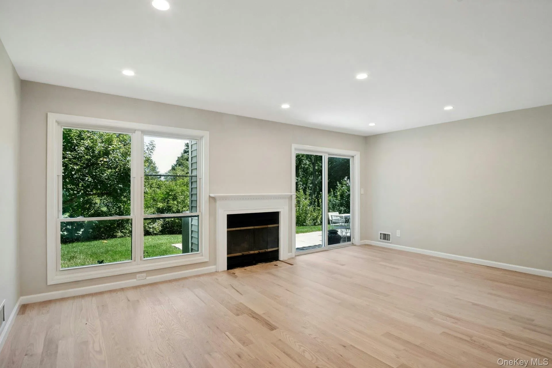 Living room features hardwood floor, fireplace and recessed lights. Living room features hardwood floor, fireplace and recessed lights.