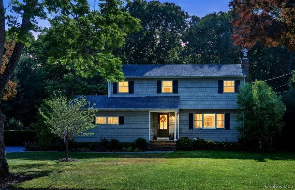 Two-story residence featuring light-colored shake siding and a dark shingle roof Two-story residence featuring light-colored shake siding and a dark shingle roof