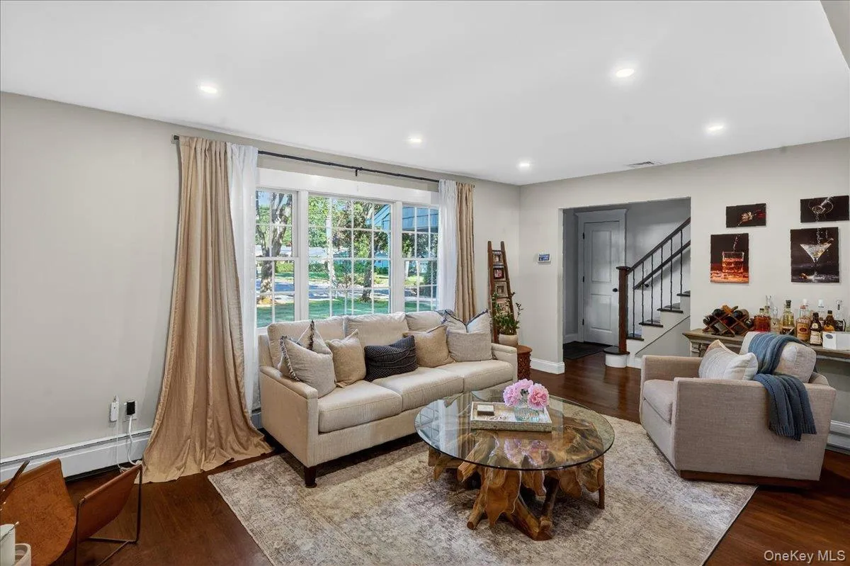 Living area featuring recessed lighting and wood-finish flooring Living area featuring recessed lighting and wood-finish flooring