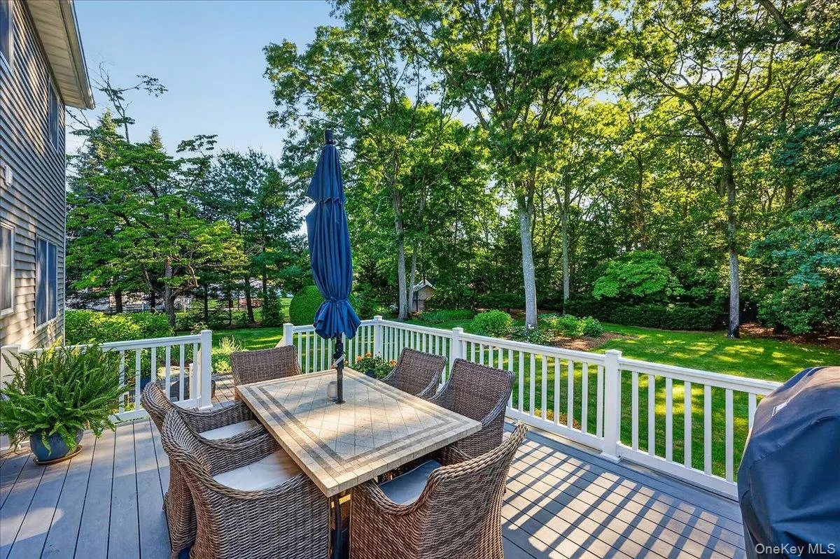 Expansive rear deck featuring composite decking and white railing Expansive rear deck featuring composite decking and white railing