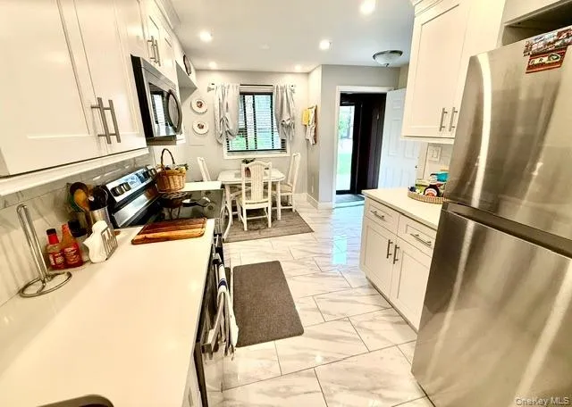 Kitchen looking towards kitchen table and front door Kitchen looking towards kitchen table and front door