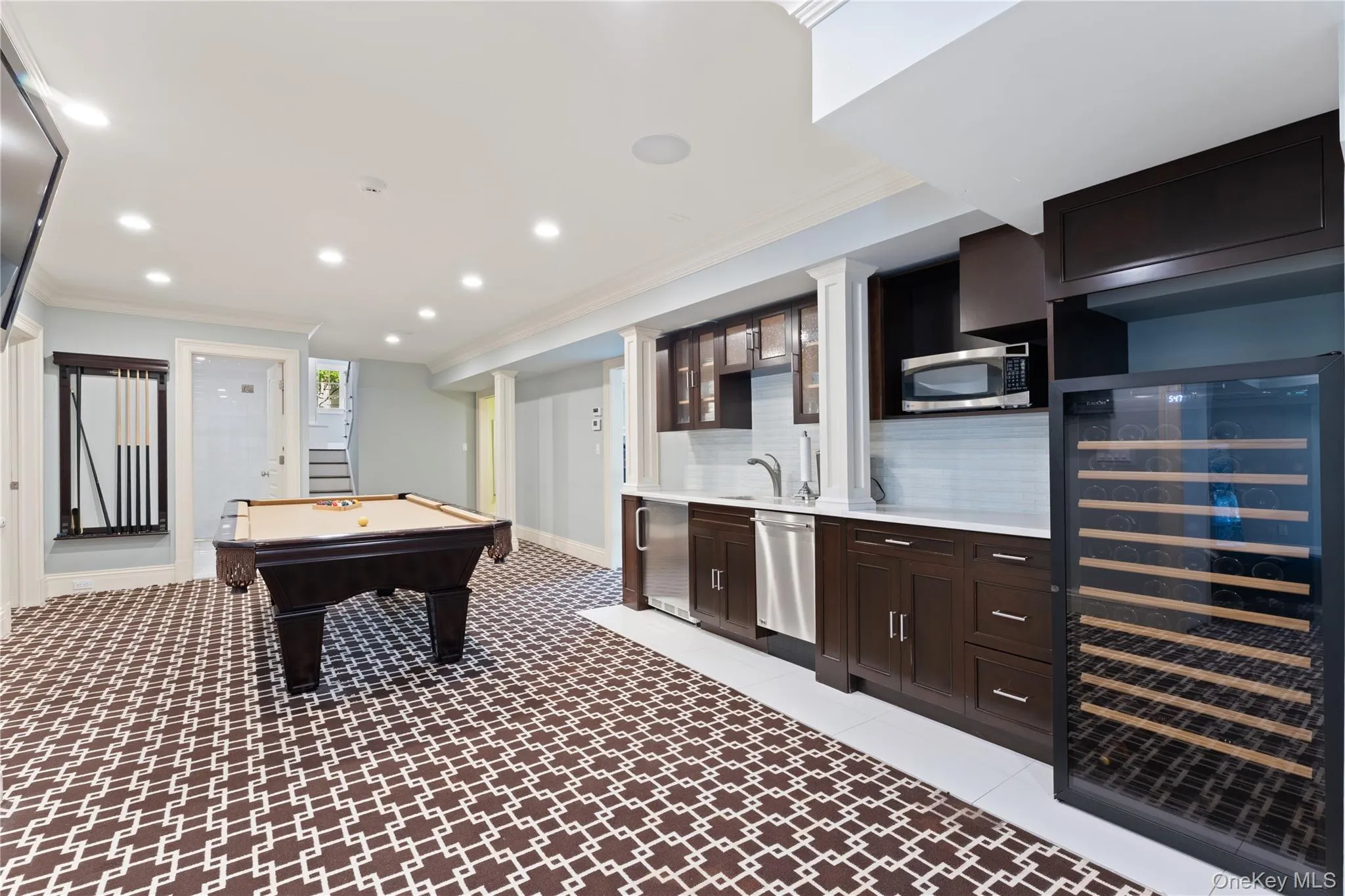 recreation room includes custom entertaining bar with sink, ice maker, beverage refrigerator, wine refrigerator, custom cabinetry, marble counter top recreation room includes custom entertaining bar with sink, ice maker, beverage refrigerator, wine refrigerator, custom cabinetry, marble counter top