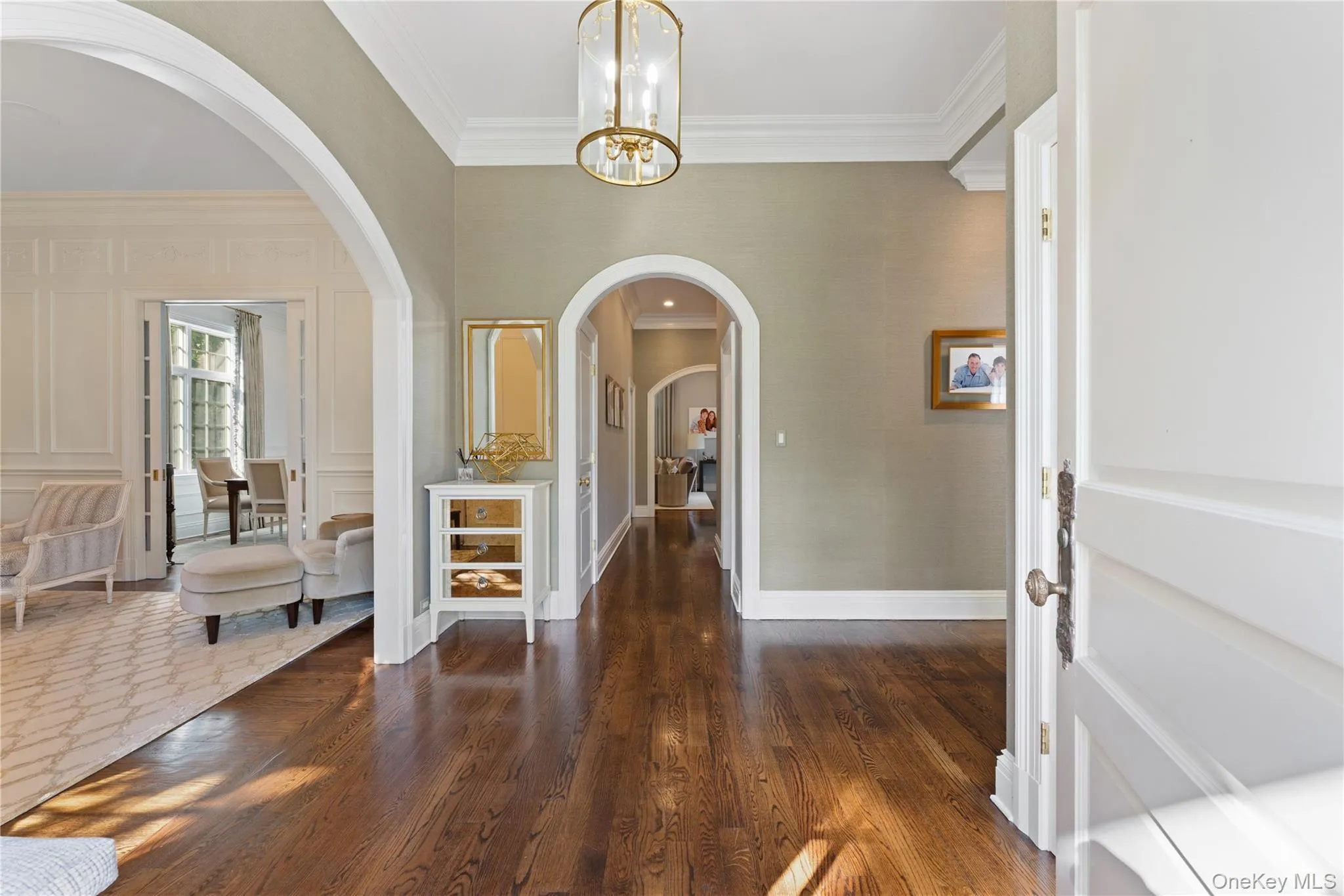 Entry way with 11’ ceilings, beautiful archways looking into the formal living room and down to the family room Entry way with 11’ ceilings, beautiful archways looking into the formal living room and down to the family room