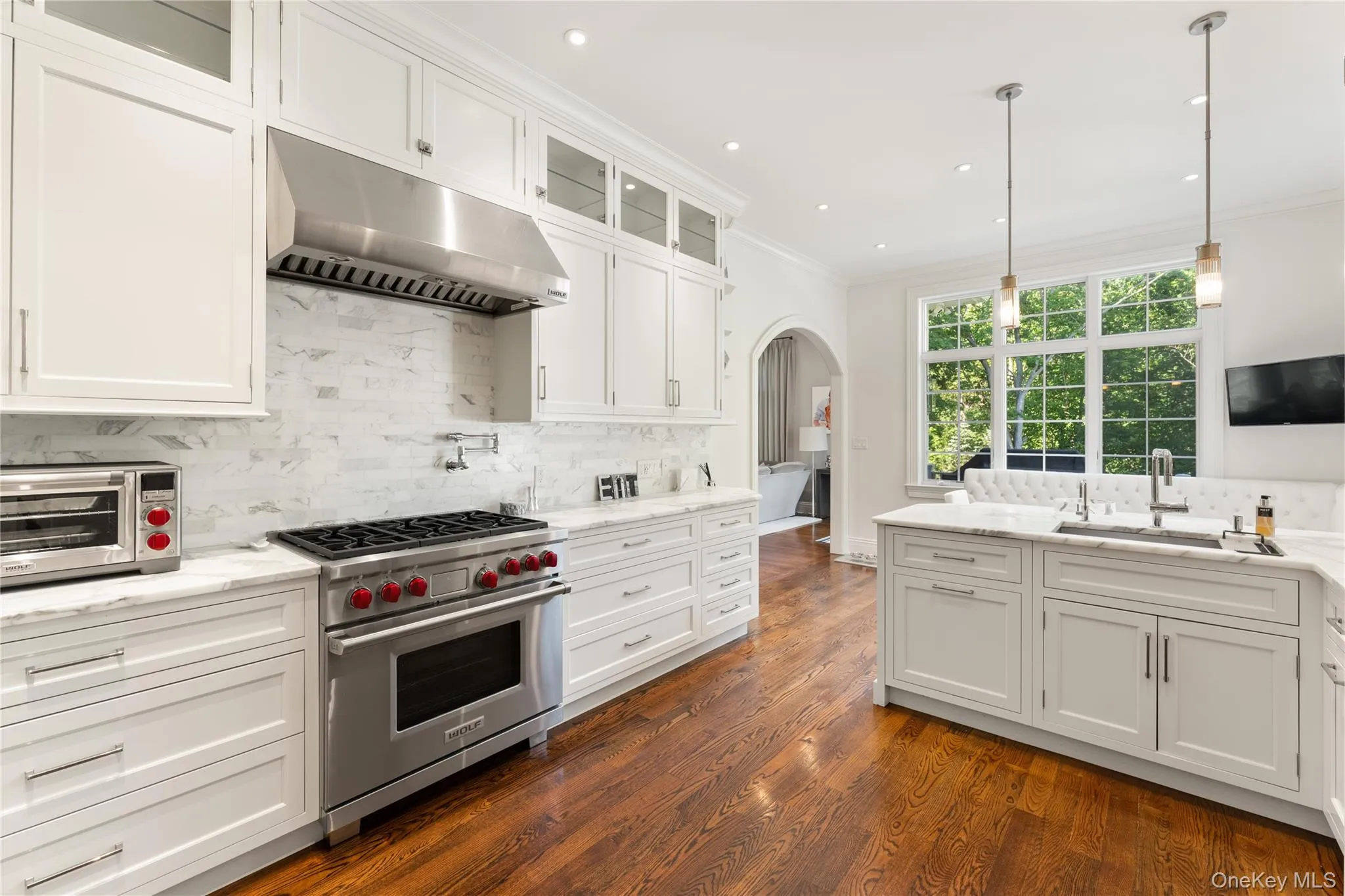 Chef’s kitchen with Sub zero refrigerator, Wolf range/oven, Miele dishwasher, Calcutta gold marble counter tops, custom cabinetry Chef’s kitchen with Sub zero refrigerator, Wolf range/oven, Miele dishwasher, Calcutta gold marble counter tops, custom cabinetry